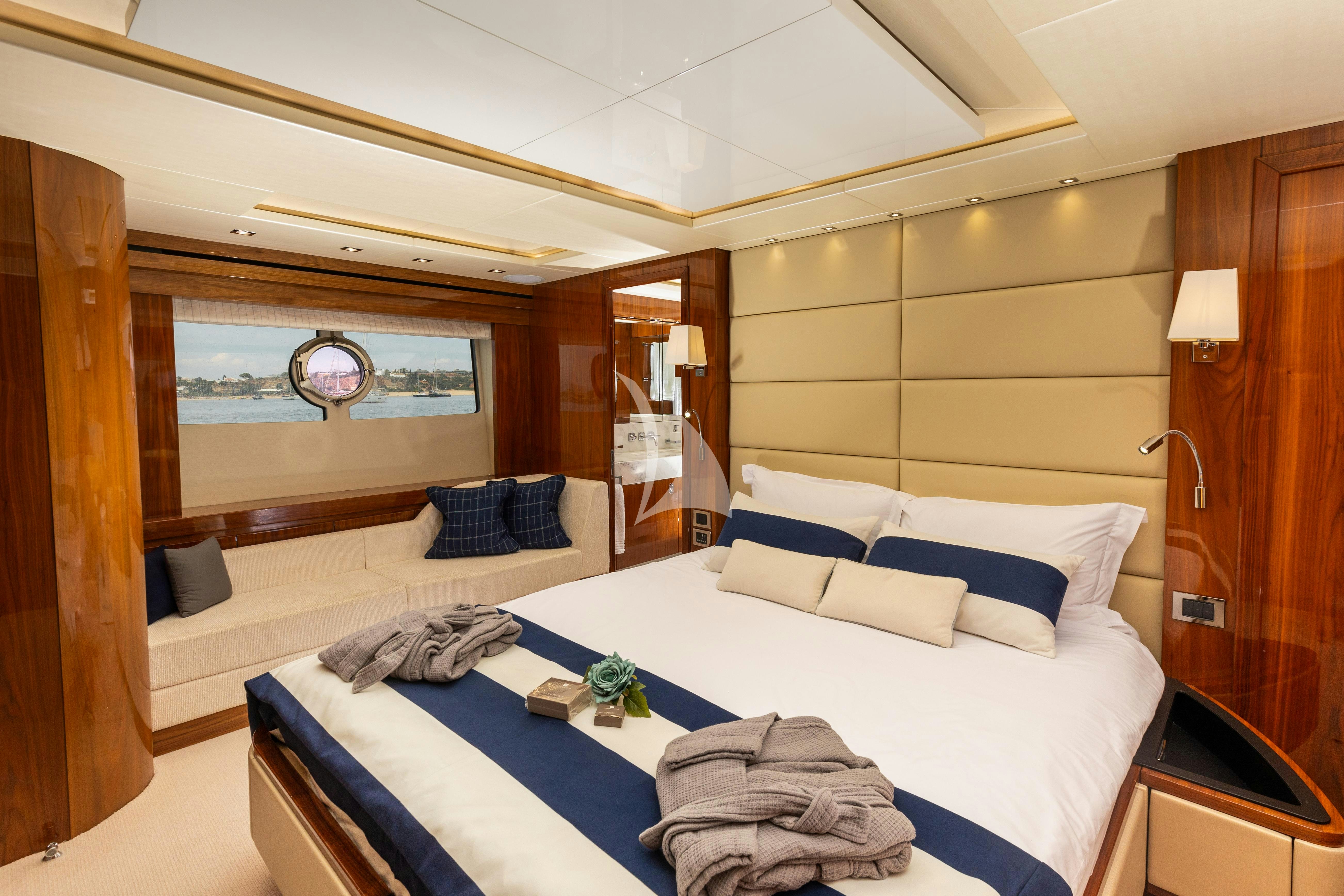 a room with a bed and a desk aboard STARDUST OF MARY Yacht for Charter