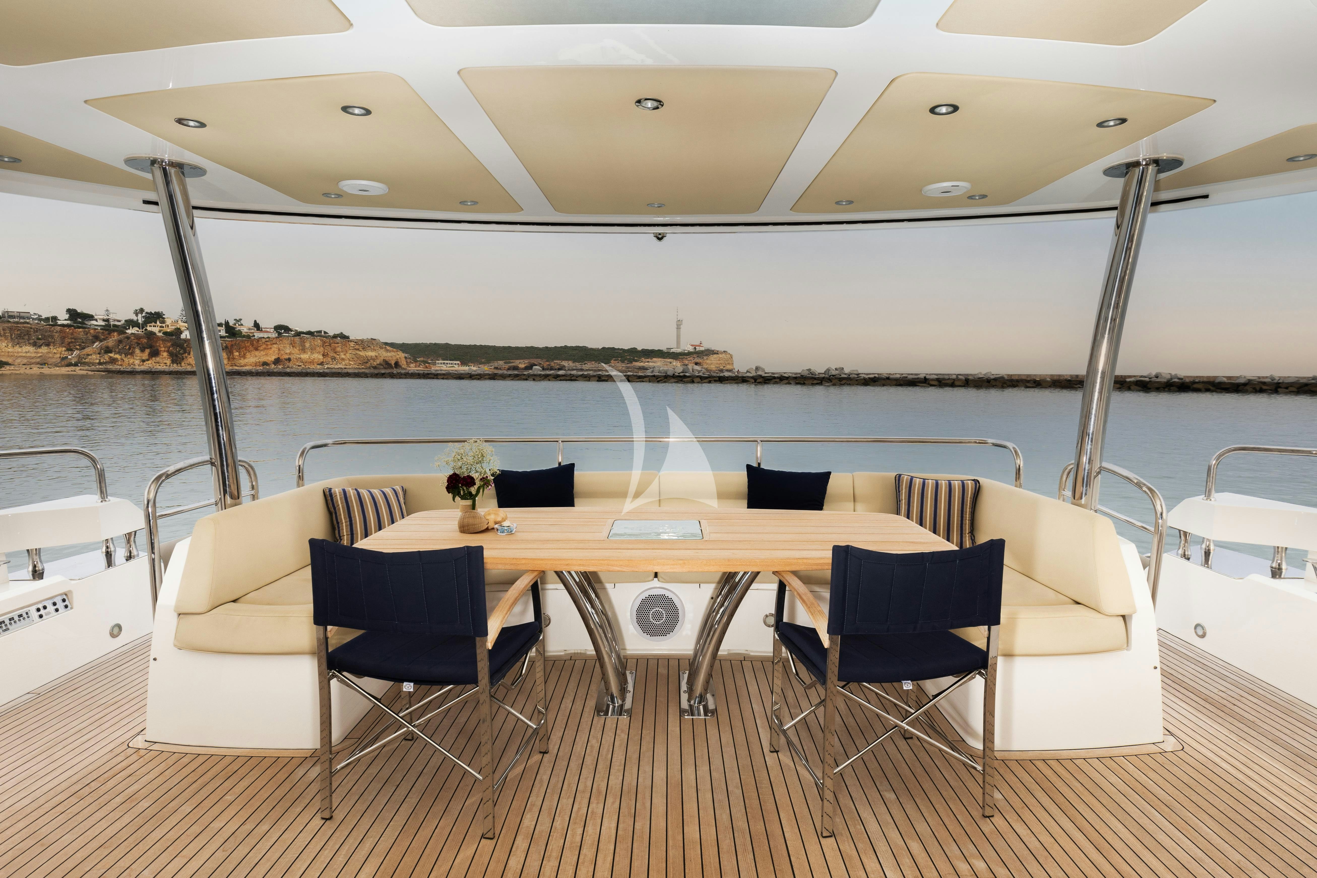 a table and chairs on a deck aboard STARDUST OF MARY Yacht for Charter