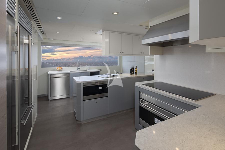 a large kitchen with white cabinets aboard ENTREPRENEUR Yacht for Charter