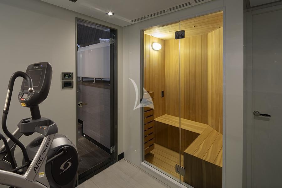 a room with a bike and a door aboard ENTREPRENEUR Yacht for Charter