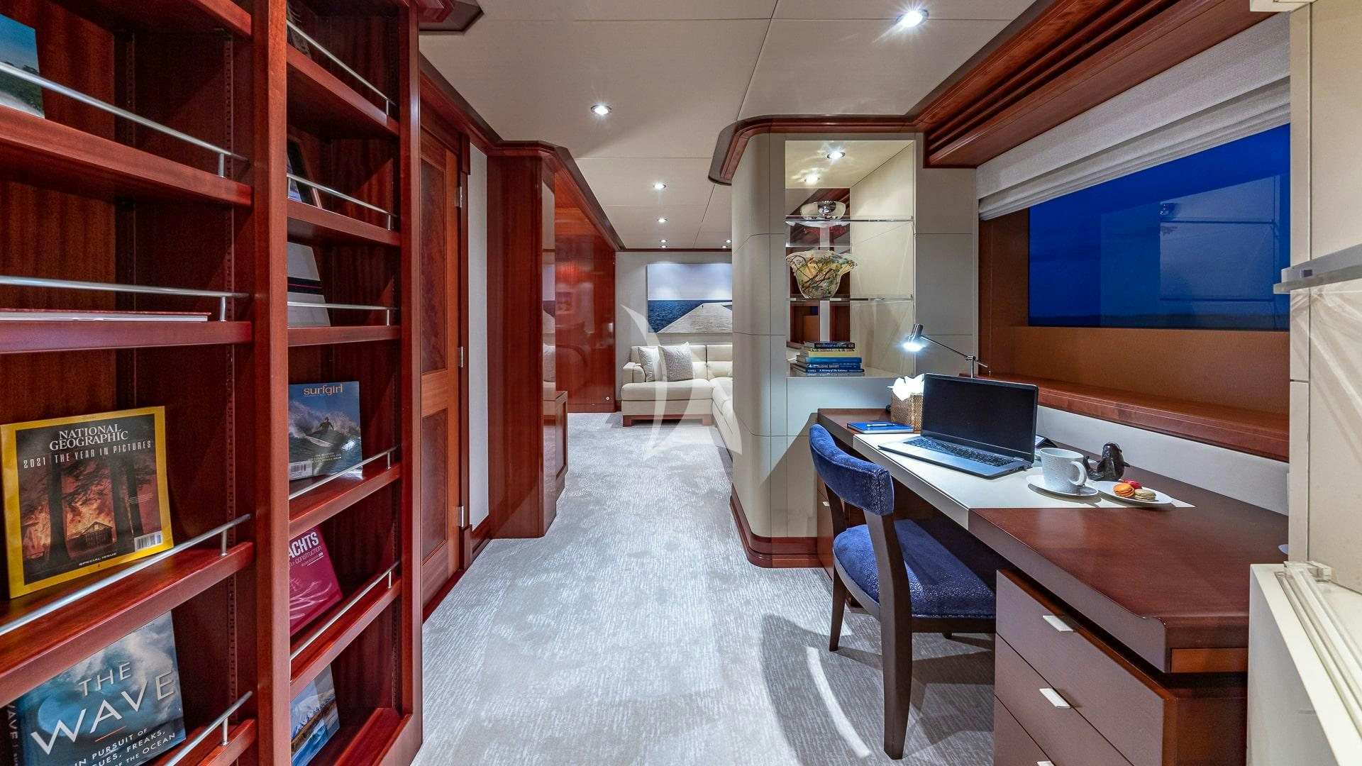a room with a desk and a laptop aboard PISCES Yacht for Charter