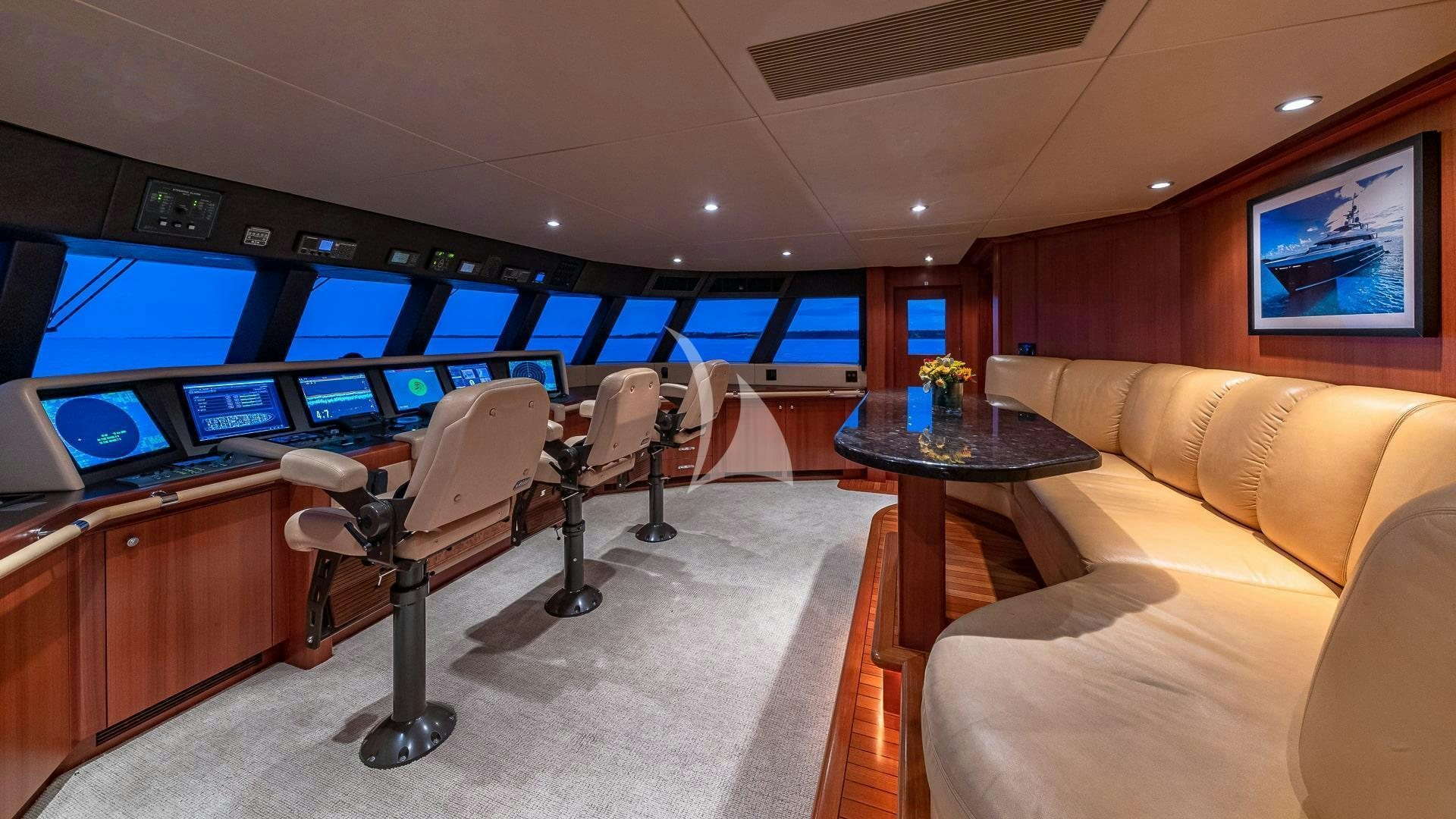 a room with a couch and a table and a tv aboard PISCES Yacht for Charter