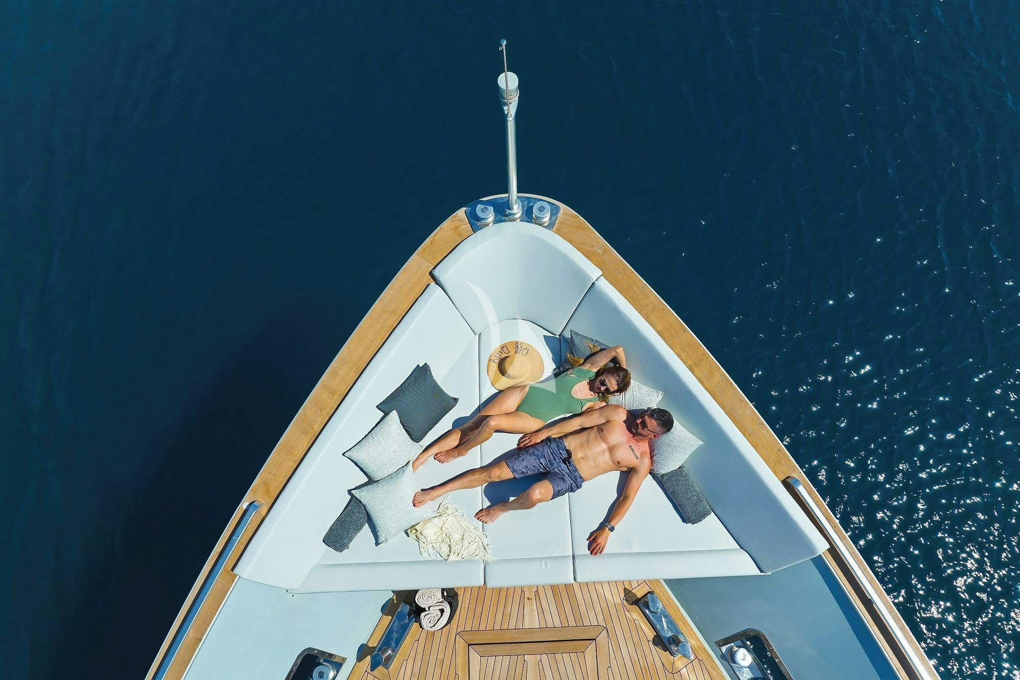 a man and a woman on a white boat aboard ANAVI Yacht for Charter