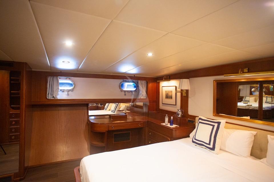 a hotel room with a bed and desk aboard SPIRIT OF MK Yacht for Charter