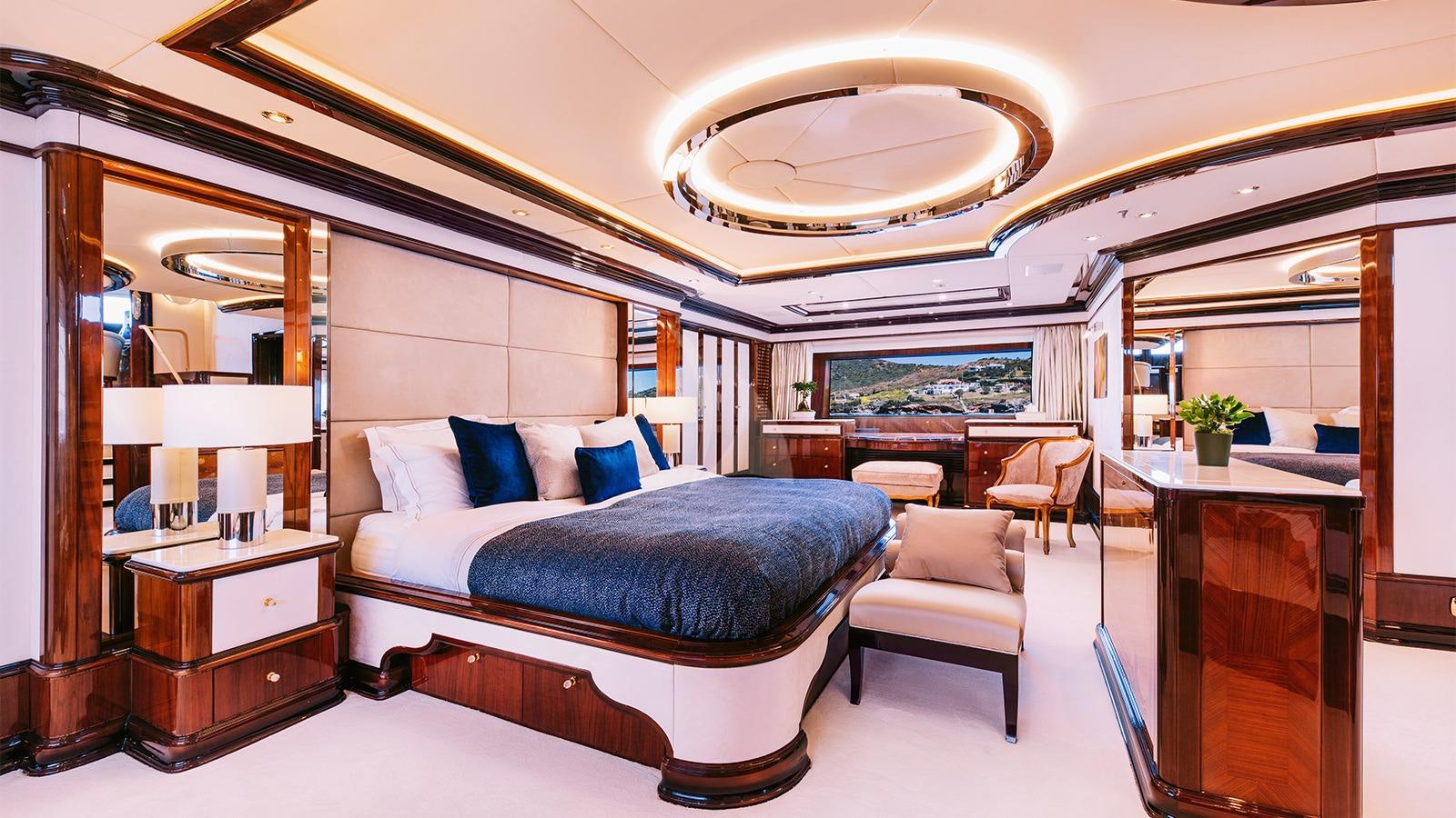 a bedroom with a bed and a desk aboard IDYLLIC Yacht for Charter