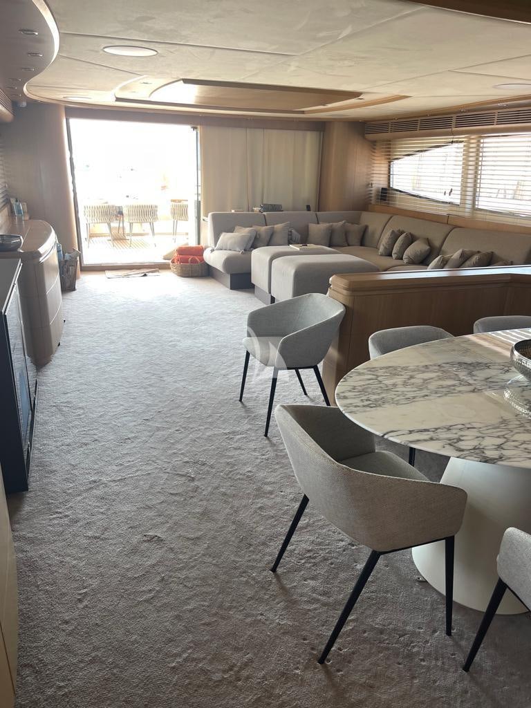 a living room with a table and chairs aboard B4 Yacht for Charter