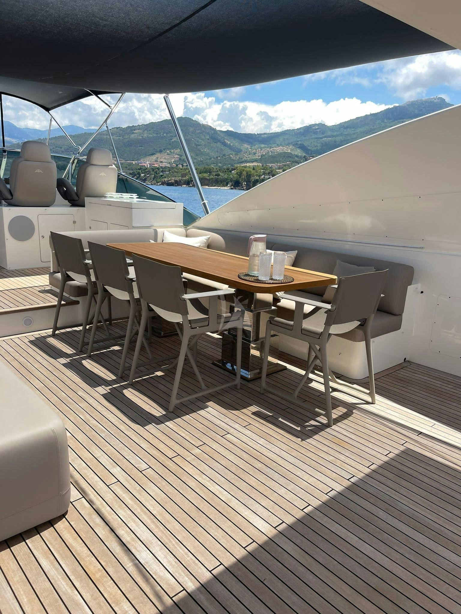 a deck with a table and chairs aboard B4 Yacht for Charter