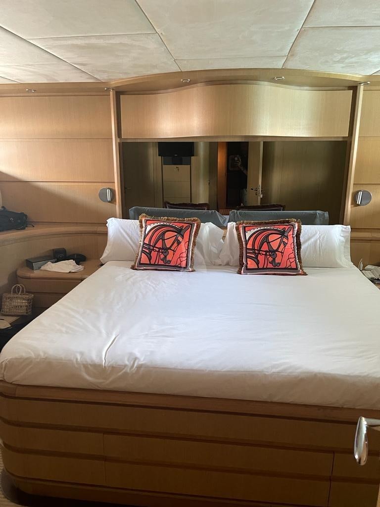 a bed with pillows aboard B4 Yacht for Charter
