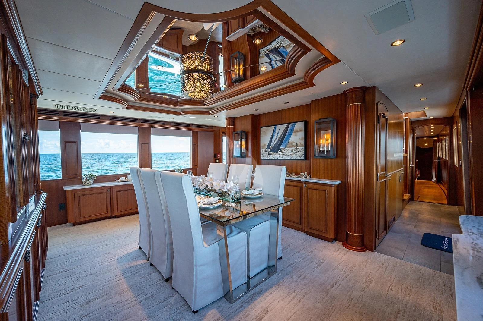 a dining room with a large open kitchen and dining area aboard MAGNUM RIDE Yacht for Charter