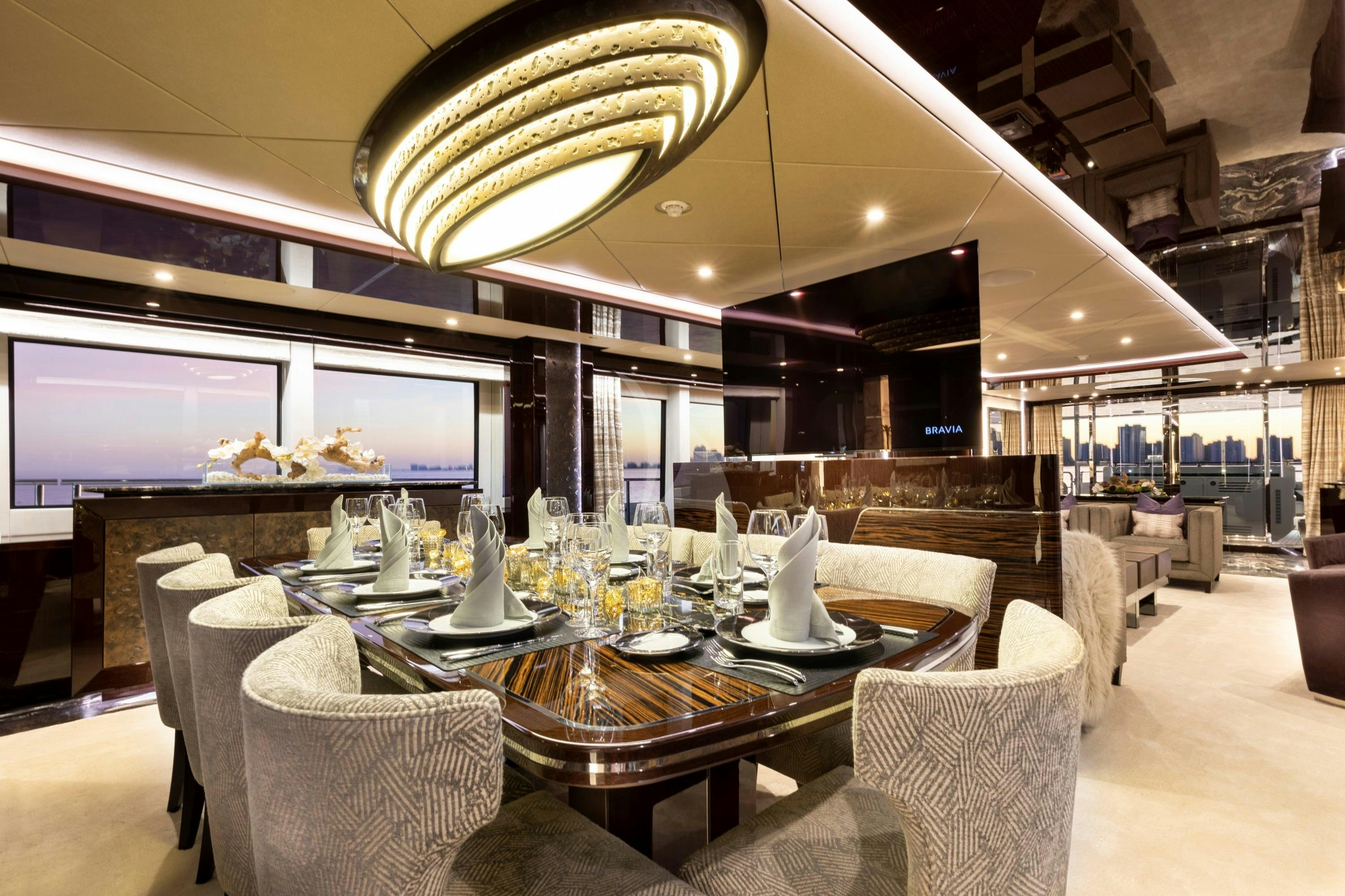 a large room with tables and chairs aboard EXODUS Yacht for Charter
