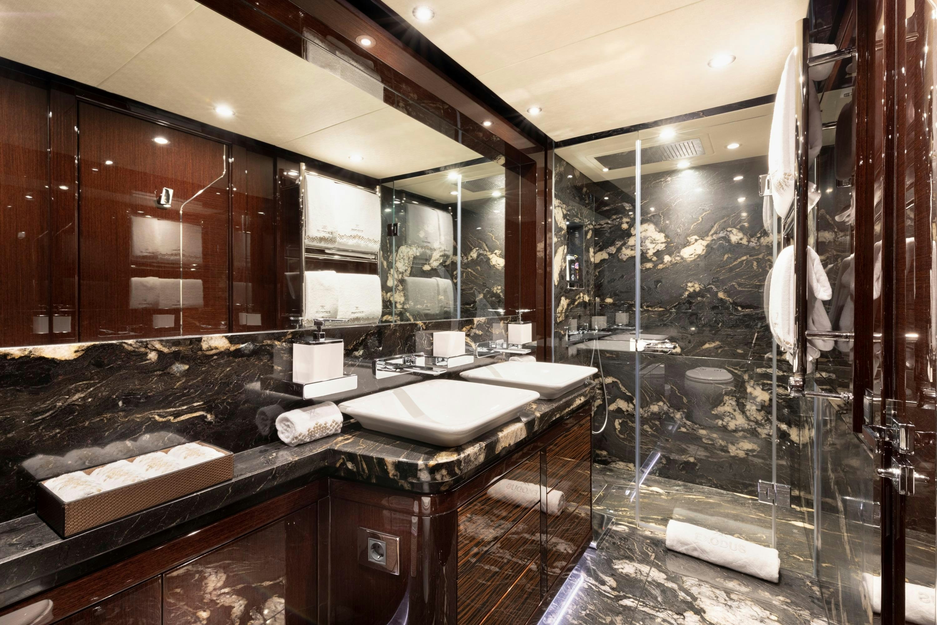 a bathroom with a large mirror aboard EXODUS Yacht for Charter