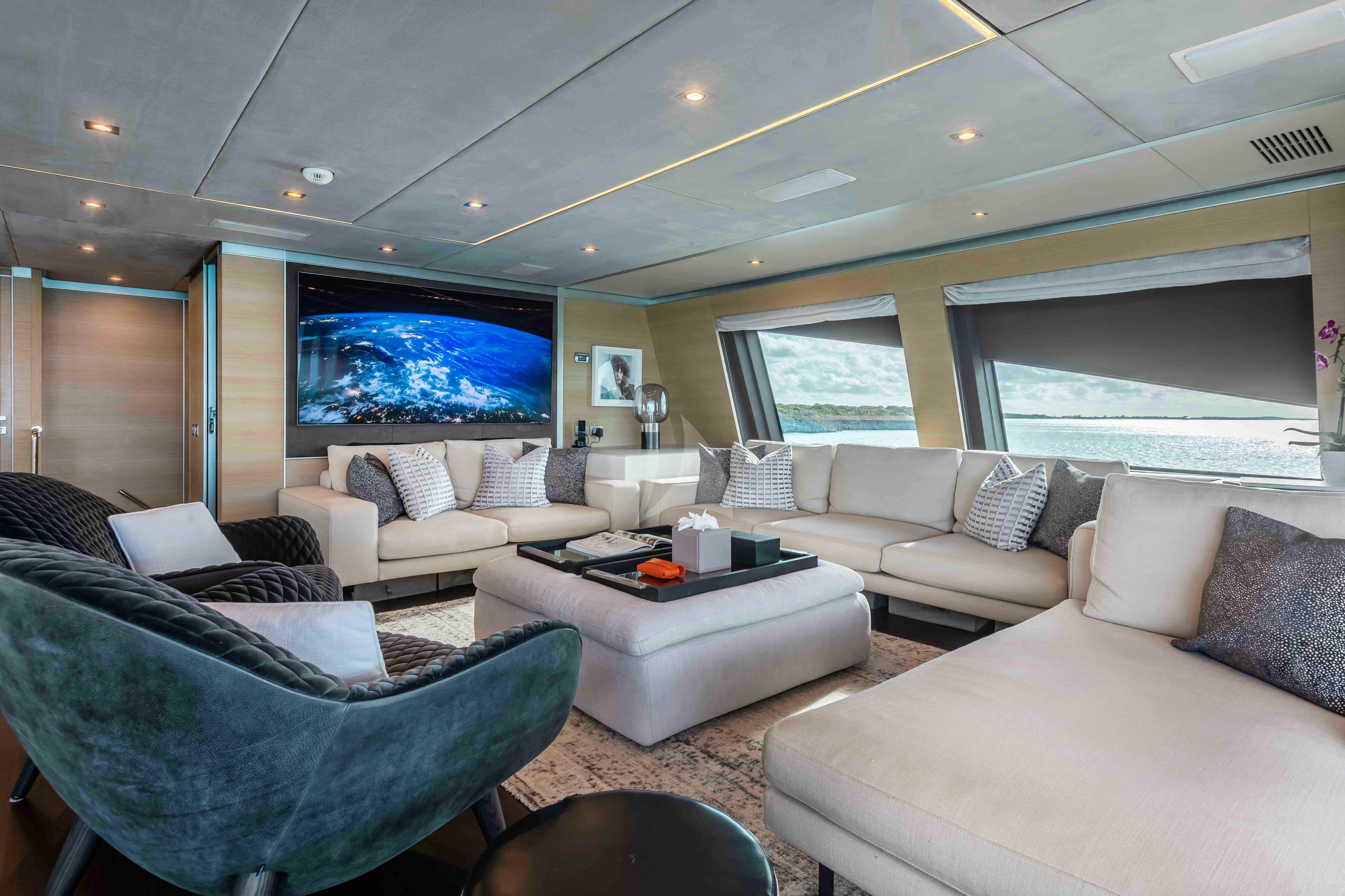 a living room with a large screen aboard EMINA Yacht for Charter