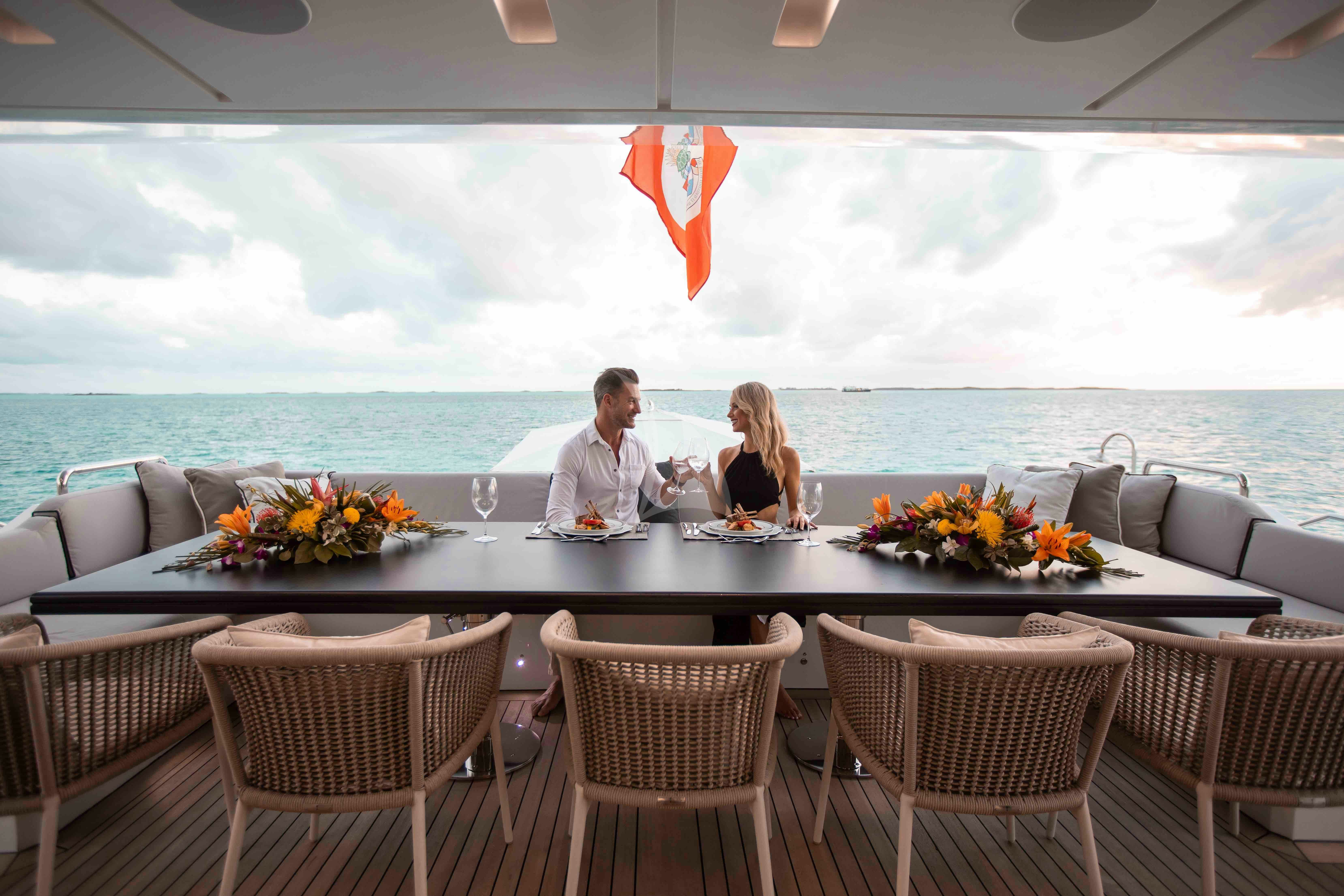 a couple sitting at a table aboard EMINA Yacht for Charter