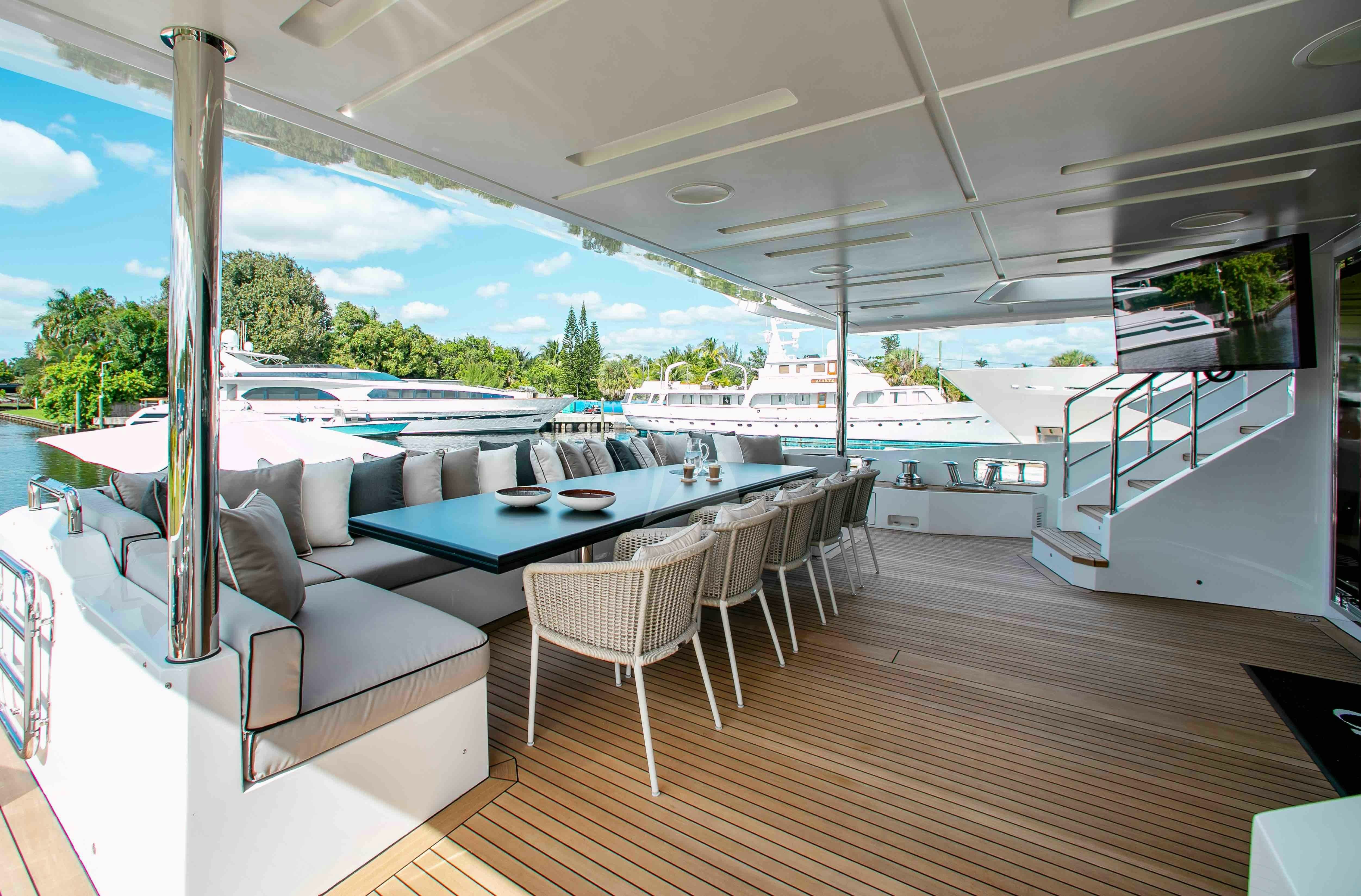 a large living room with a large deck and a pool aboard EMINA Yacht for Charter