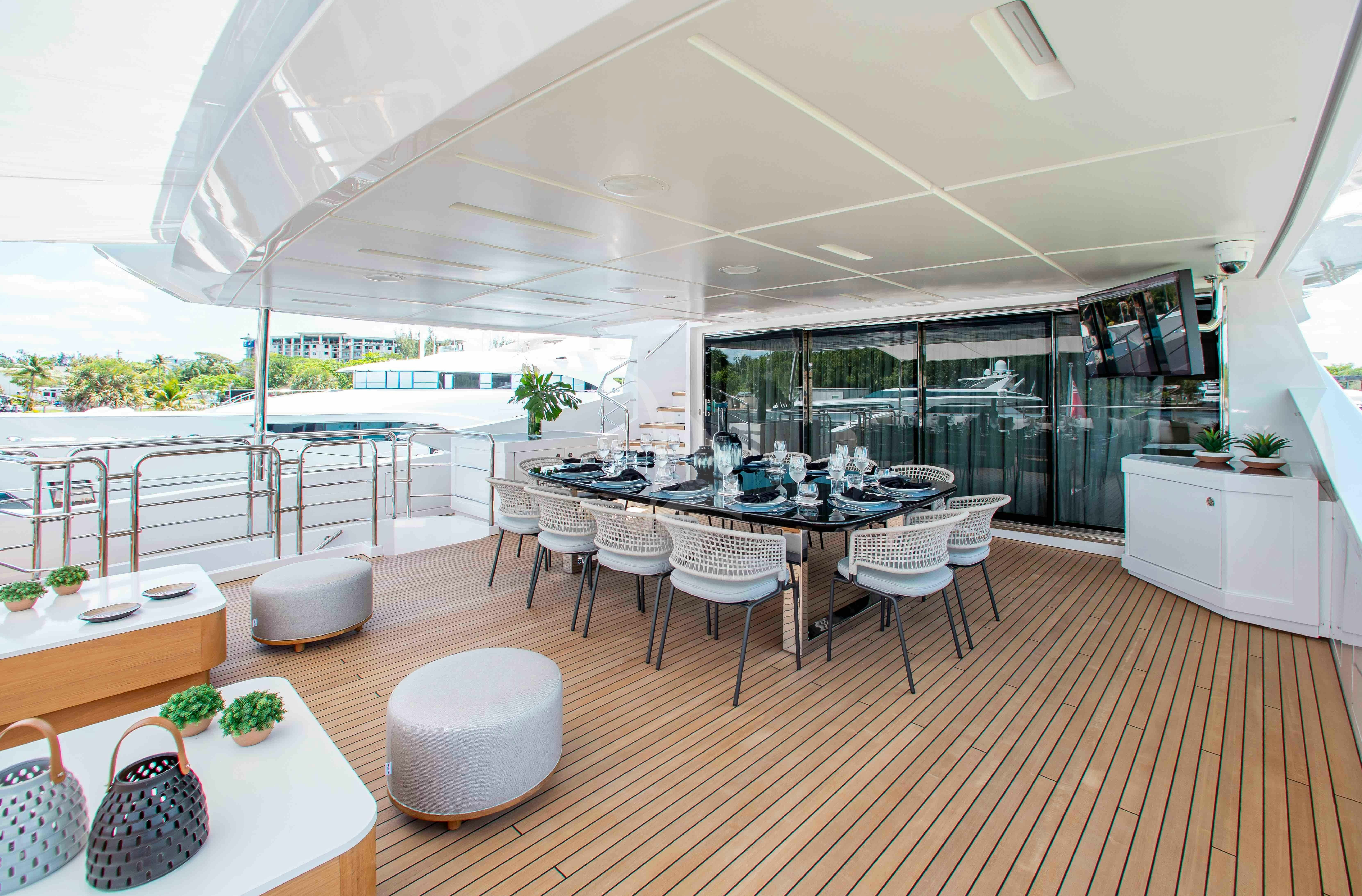 a large room with tables and chairs aboard EMINA Yacht for Charter