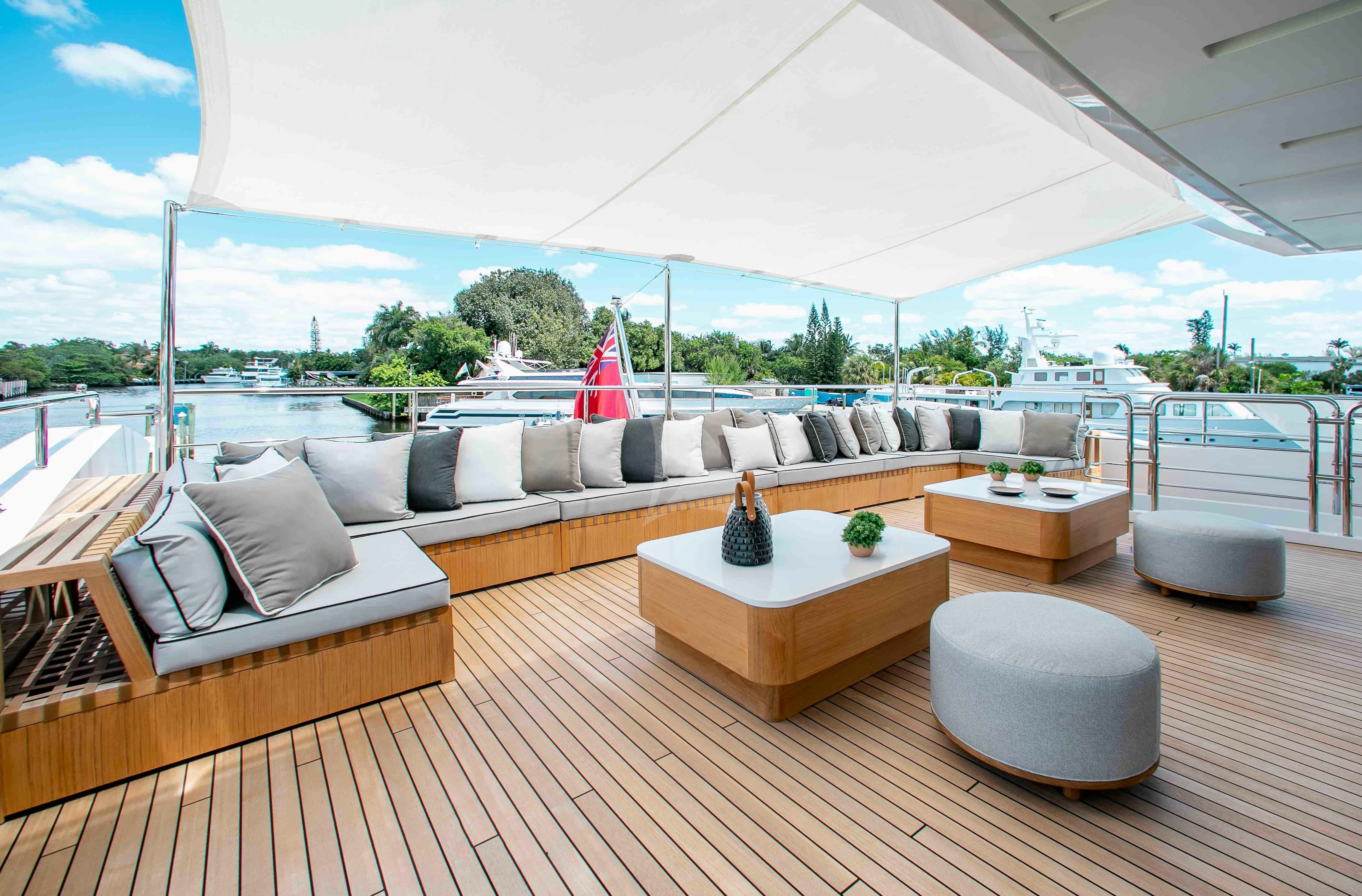 a large room with couches and a large white tent aboard EMINA Yacht for Charter