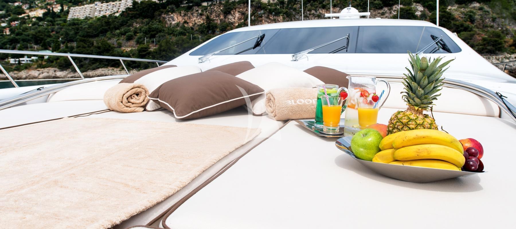 a white convertible car with a tray of fruits and drinks on it aboard BLOOMS Yacht for Charter