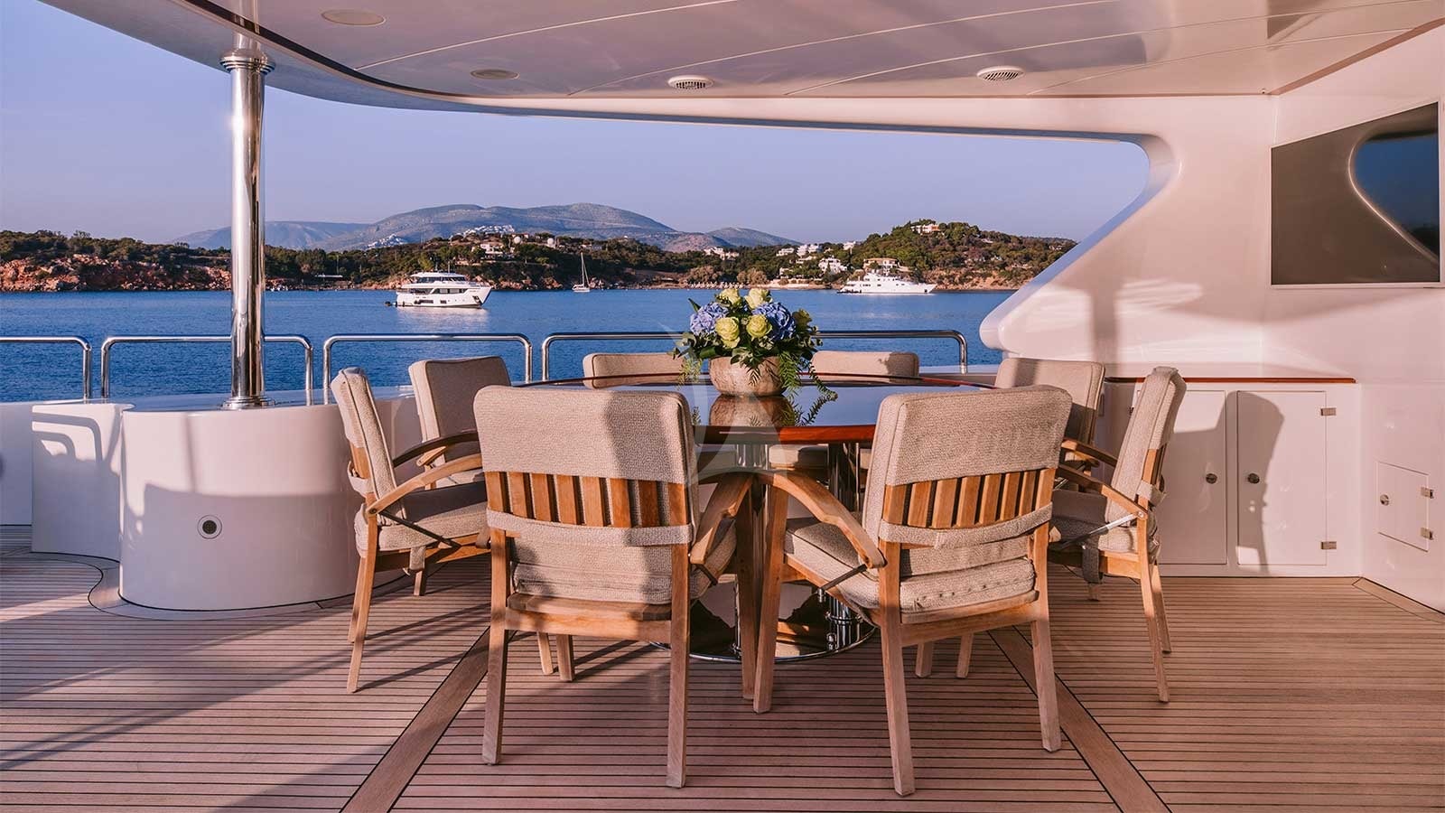 a table and chairs on a deck aboard OAK Yacht for Charter