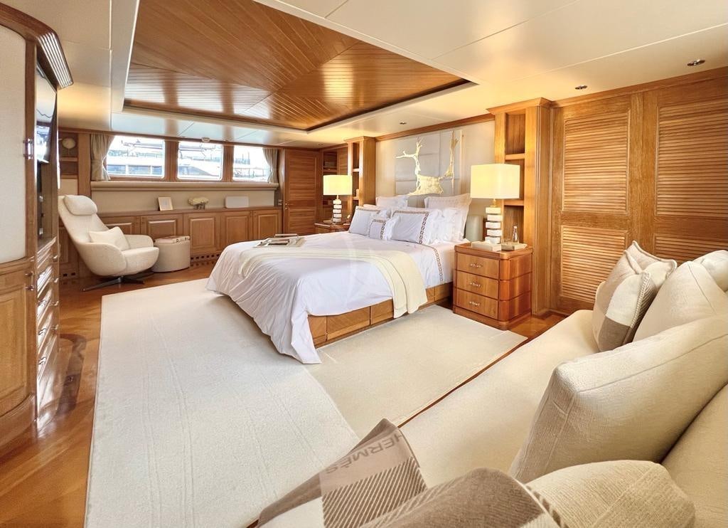 a room with a bed and a couch aboard SOLAFIDE Yacht for Charter