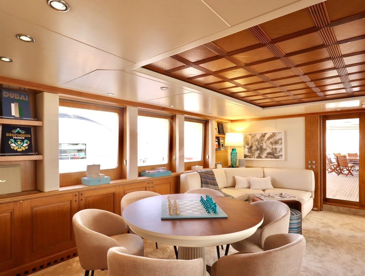 a living room with a table and chairs aboard SOLAFIDE Yacht for Charter