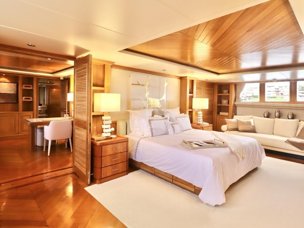 a bedroom with a bed and a desk aboard SOLAFIDE Yacht for Charter