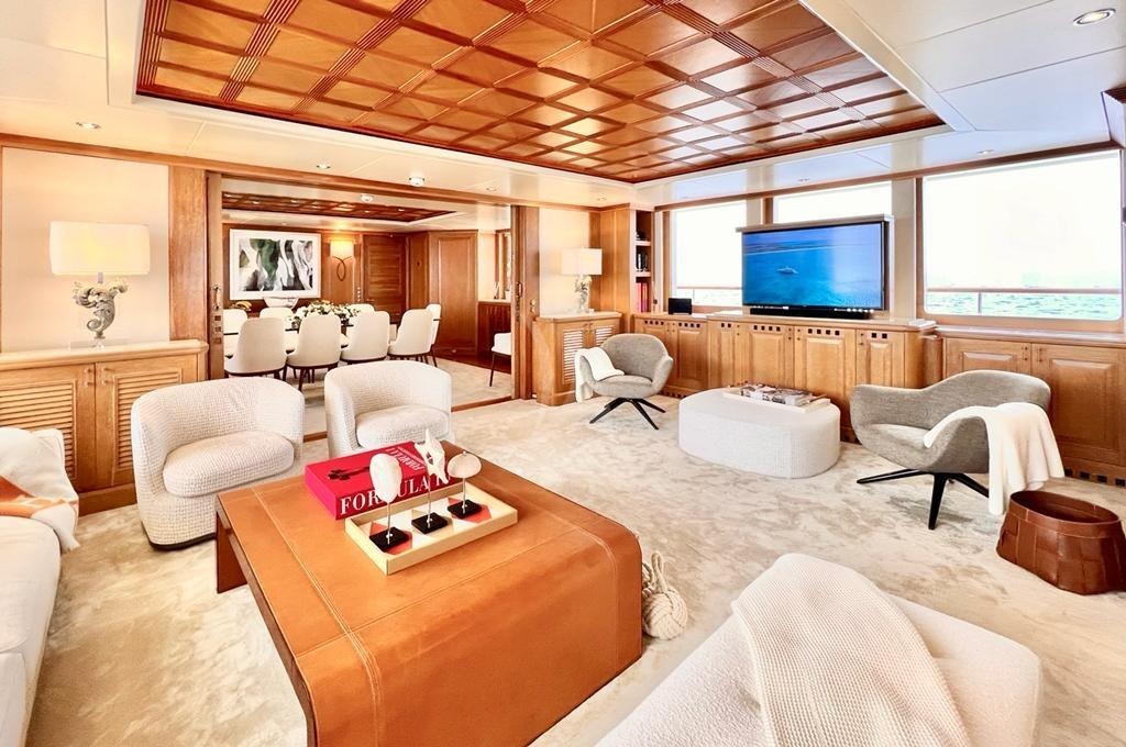 a living room with a large screen aboard SOLAFIDE Yacht for Charter