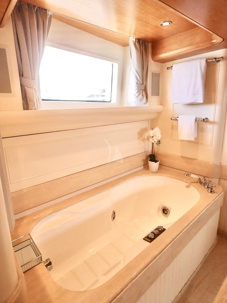 a bathroom with a tub and sink aboard SOLAFIDE Yacht for Charter