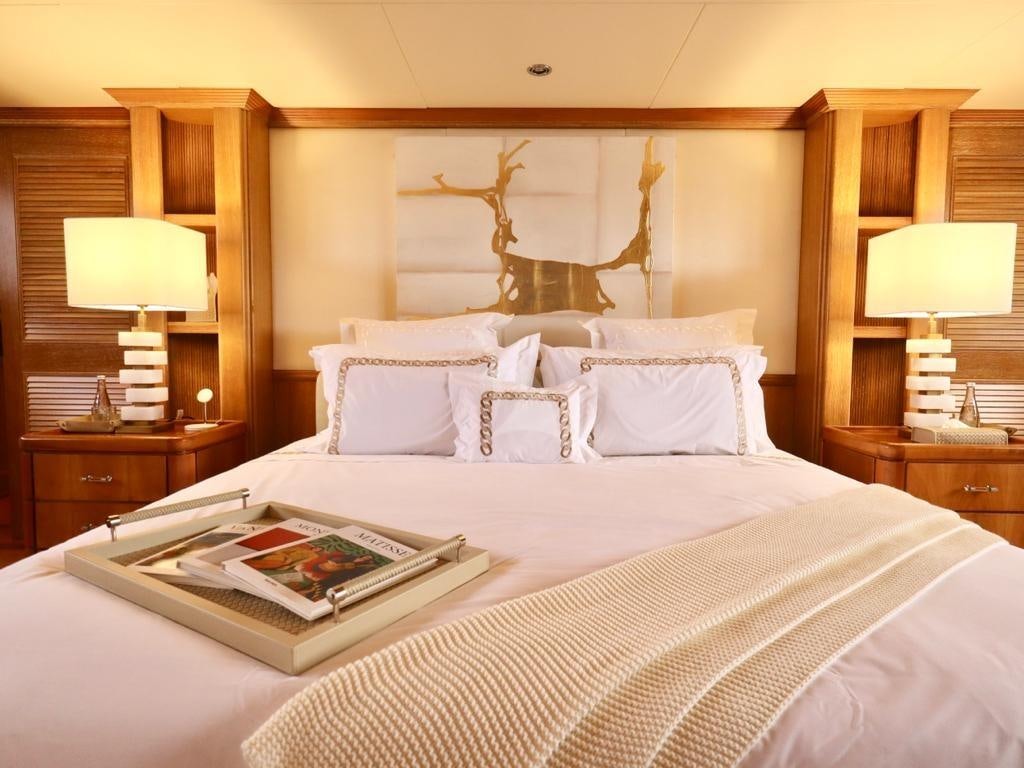 a bed with a book on it aboard SOLAFIDE Yacht for Charter