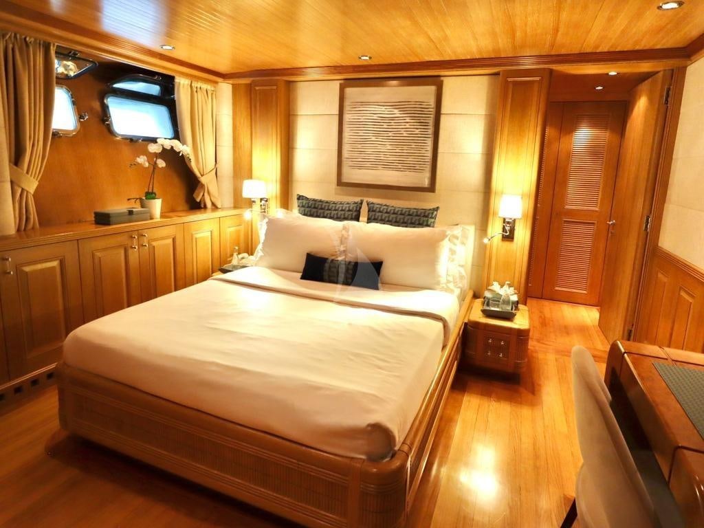 a large bedroom with a bed aboard SOLAFIDE Yacht for Charter