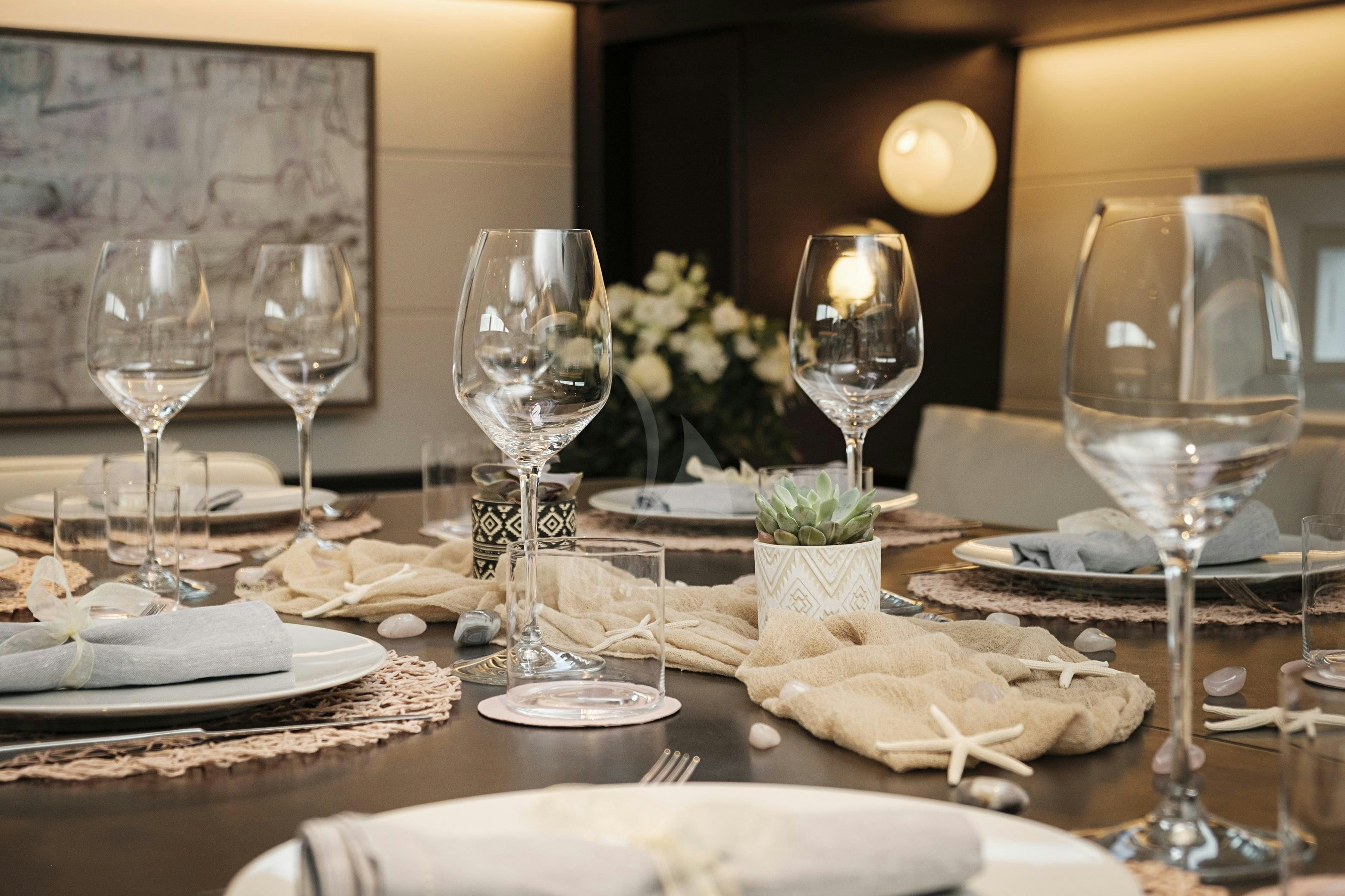a table with food and wine glasses aboard SORVIND Yacht for Charter