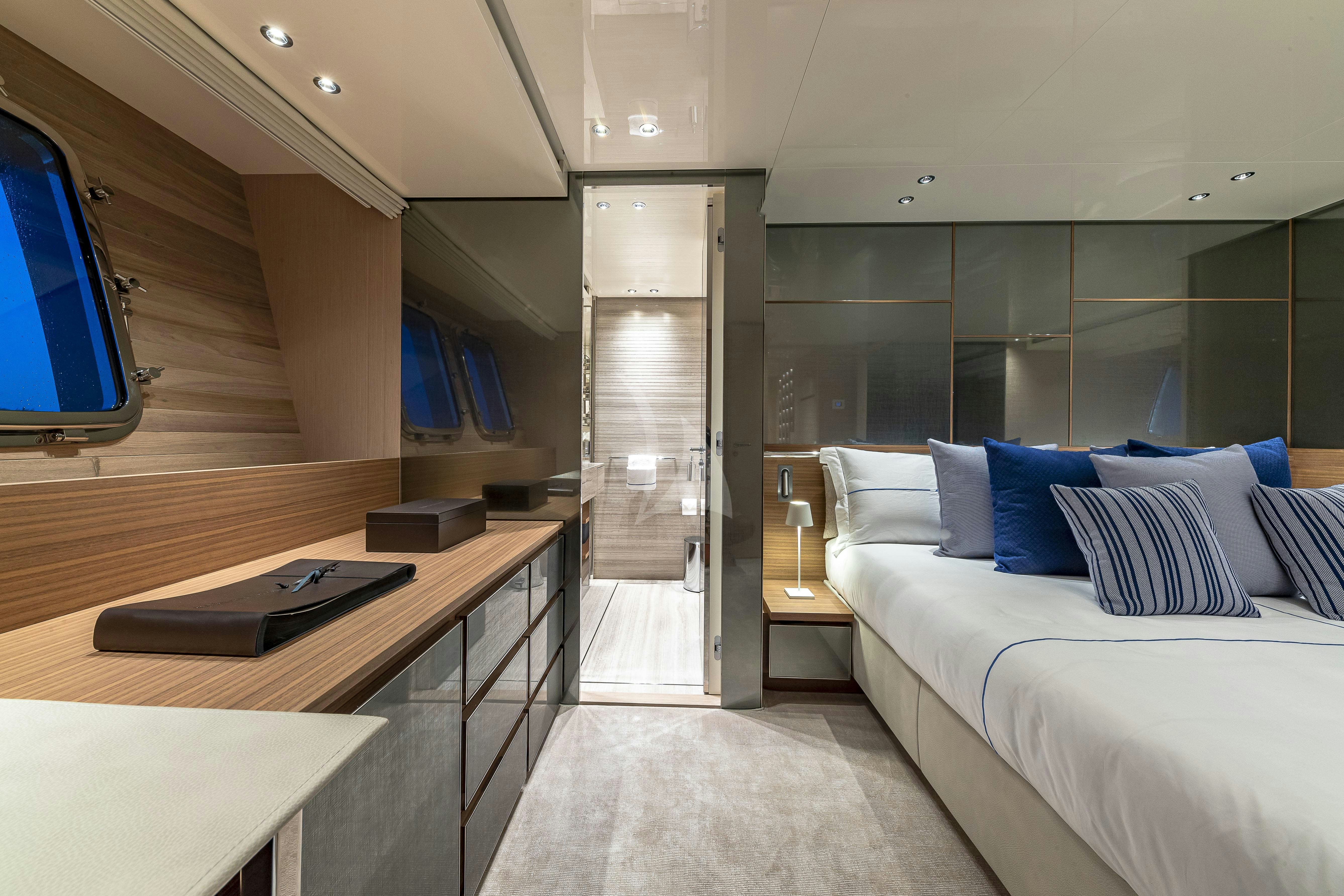 a room with a bed and a desk aboard NO MATTER WHAT Yacht for Charter