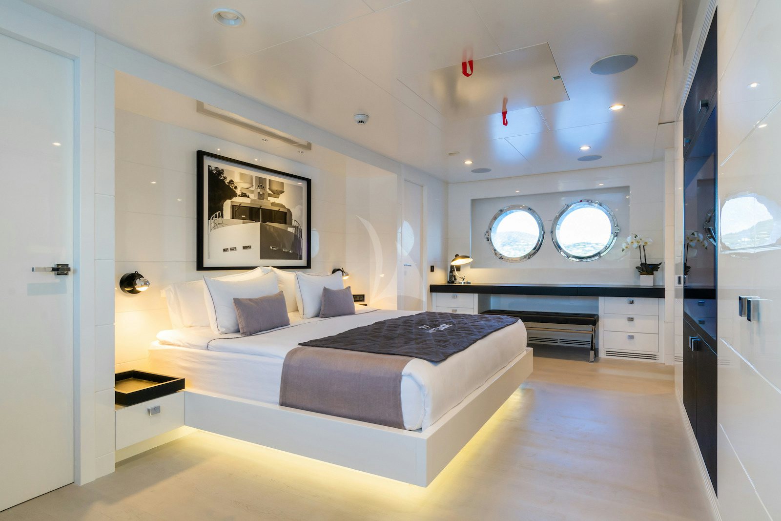 a modern bedroom with a large bed aboard S7 Yacht for Charter