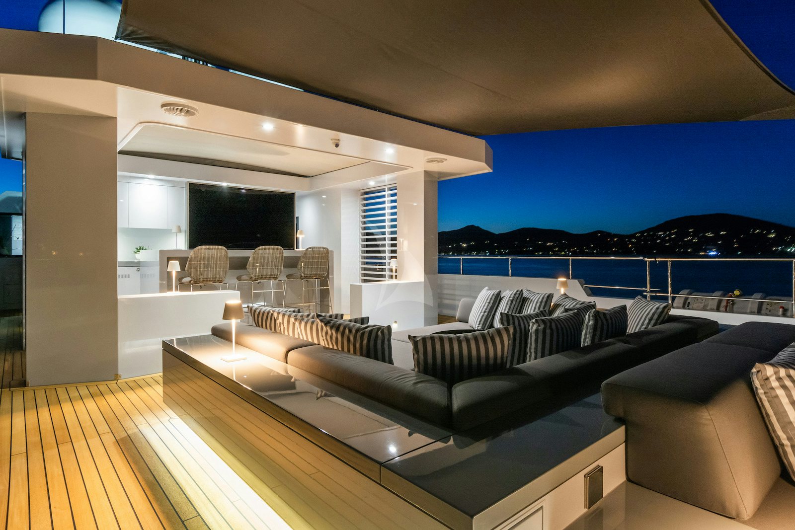 a large living room with a large balcony overlooking the ocean aboard S7 Yacht for Charter