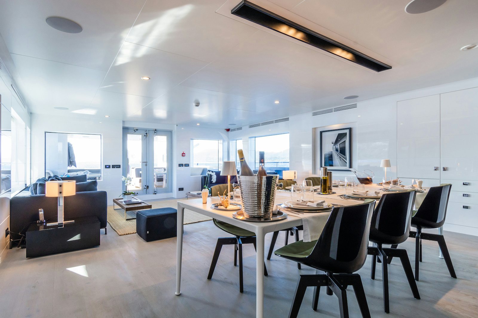 a large room with a table and chairs aboard S7 Yacht for Charter