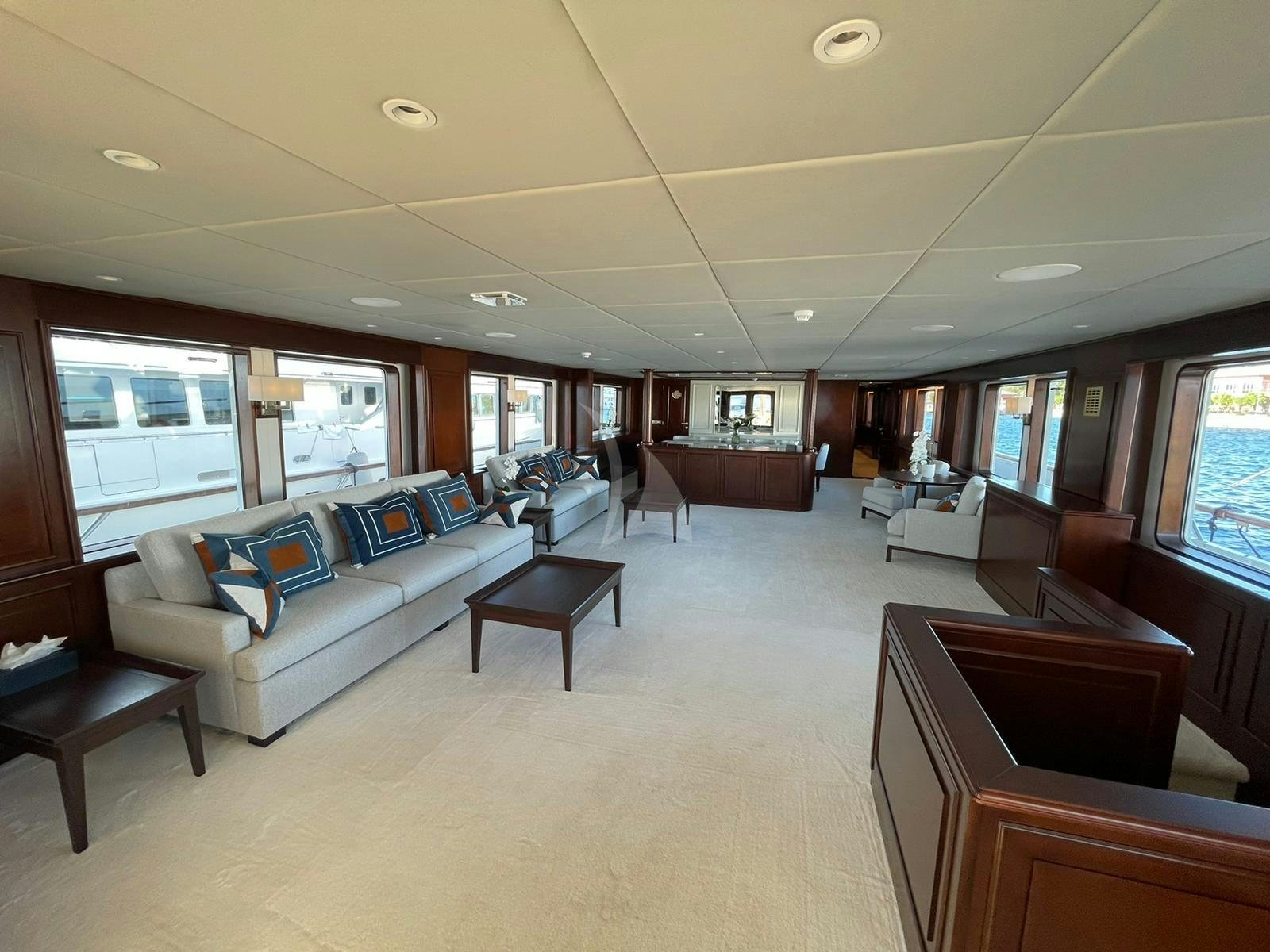 a large living room with a large window aboard GENESIA Yacht for Charter