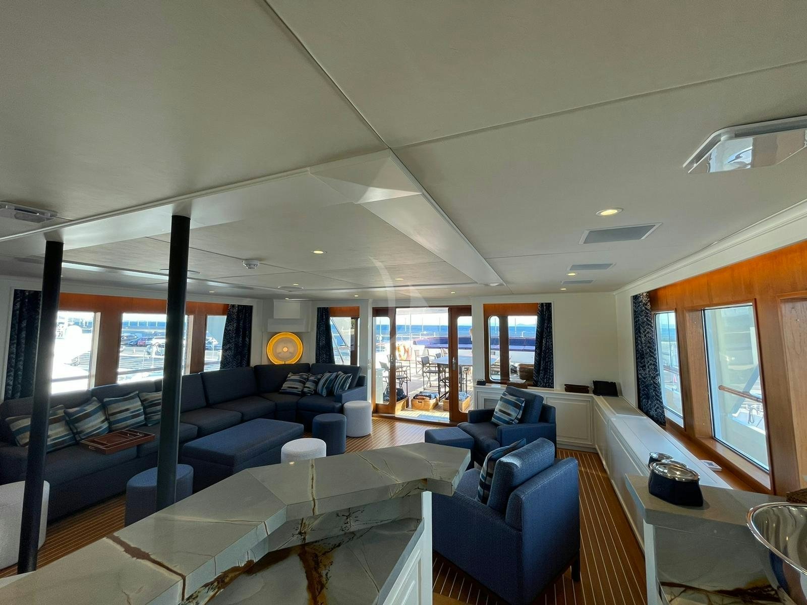 a living room with a large window aboard GENESIA Yacht for Charter