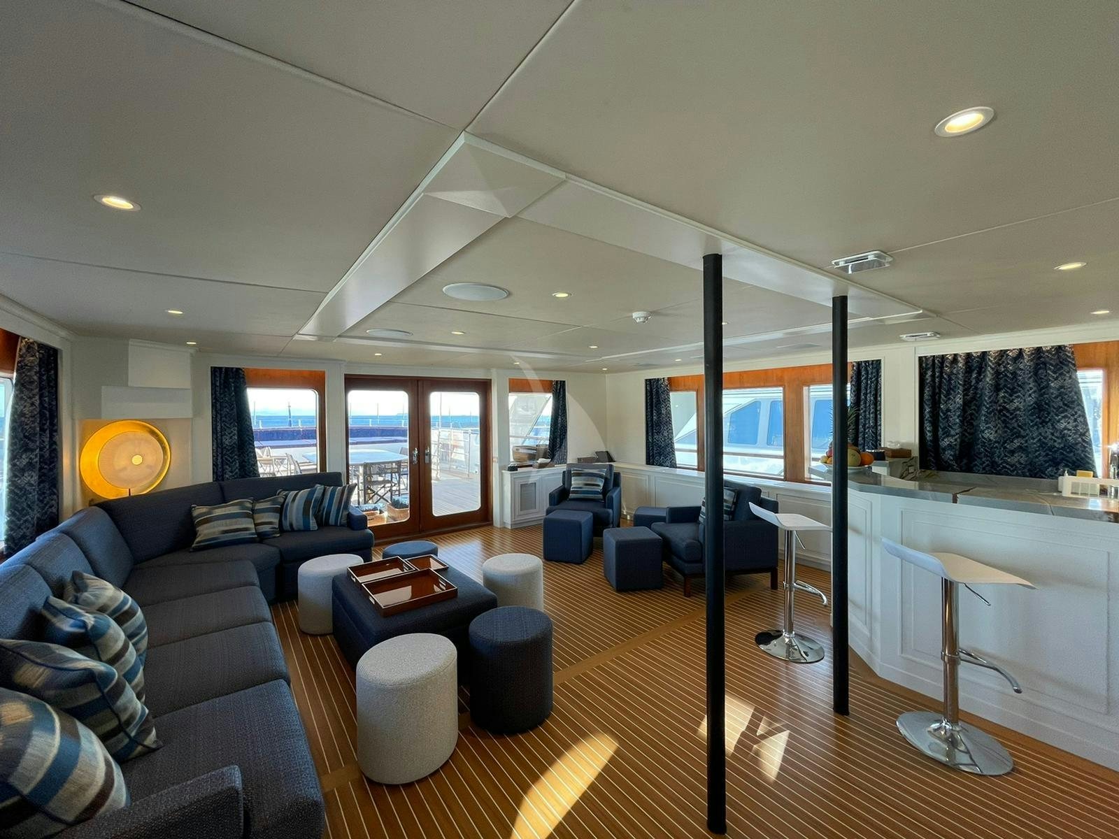 a living room with a large window aboard GENESIA Yacht for Charter