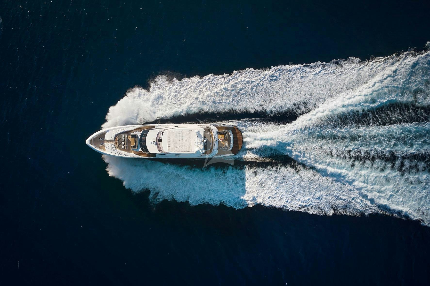 a bottle of beer on a wave aboard EVEREAST Yacht for Charter