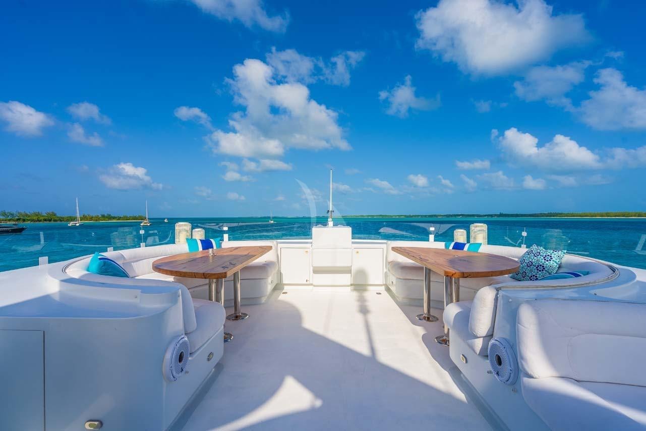 a boat dock with a table and chairs on it aboard CUPCAKE Yacht for Charter