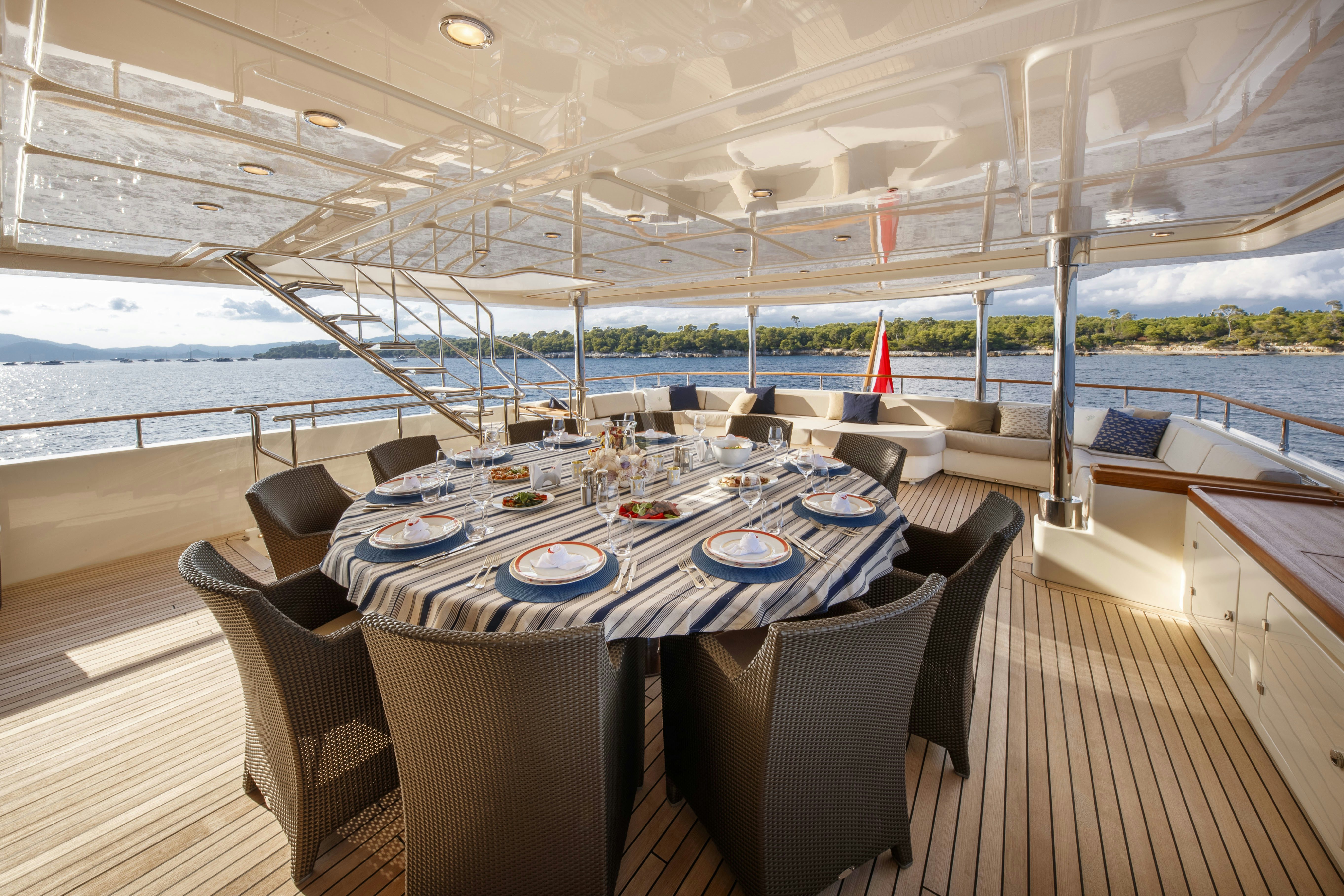 a table set for a meal on a deck aboard O'LION Yacht for Charter
