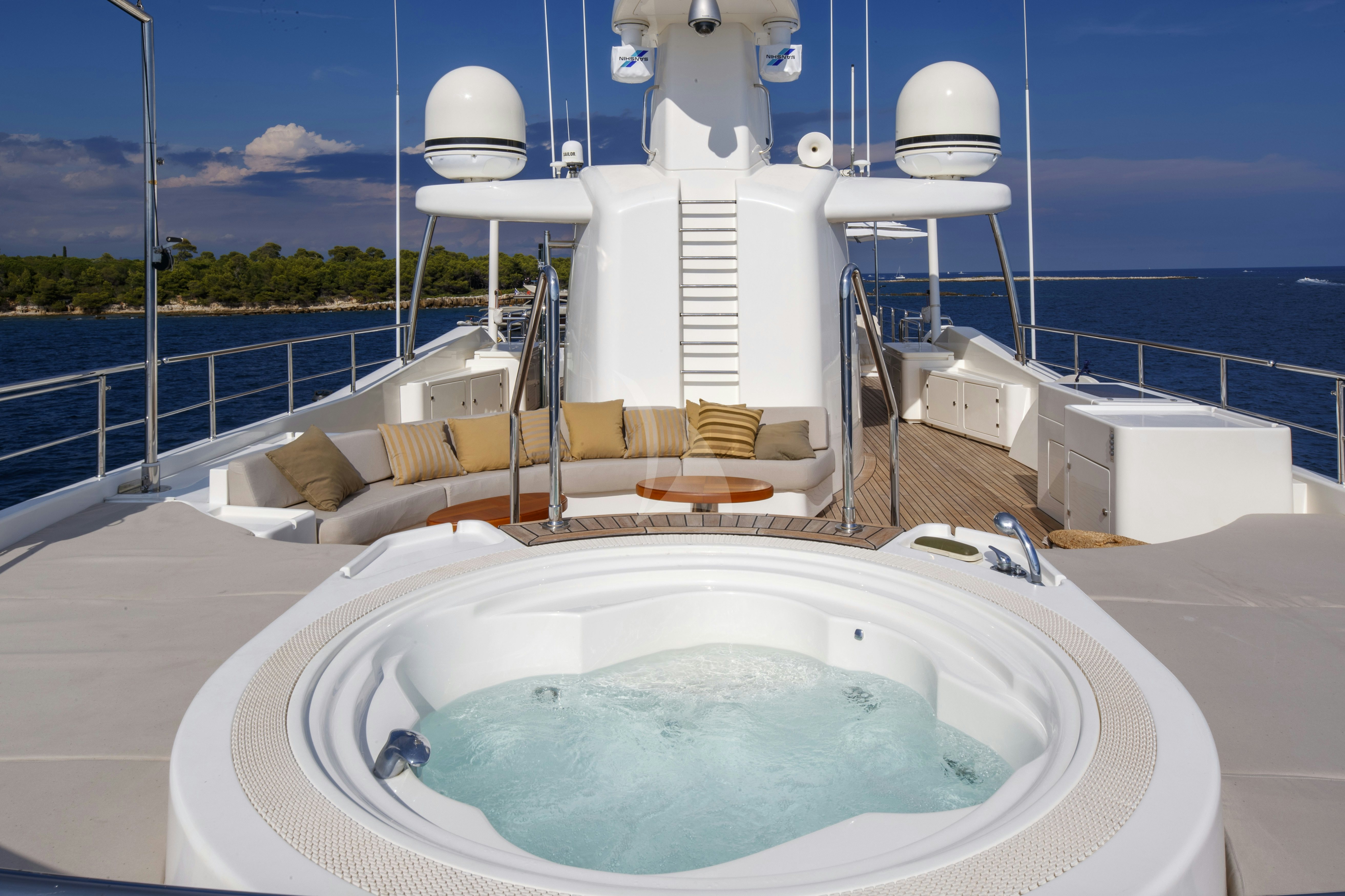 a large white bathtub with a large white tub in a room with a large window and a aboard O'LION Yacht for Charter