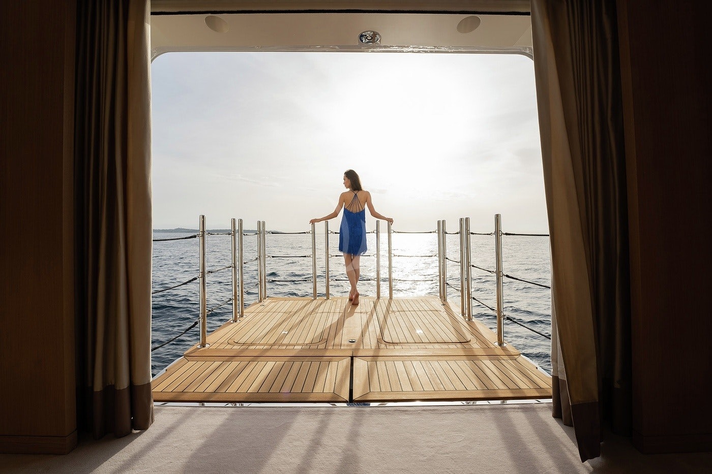 a person standing on a wooden dock aboard ARTISAN Yacht for Charter