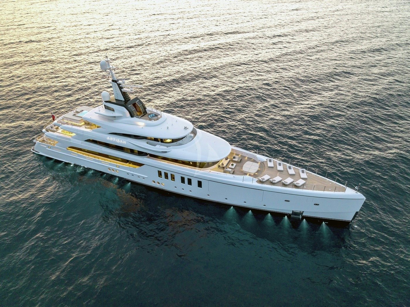 a small white boat in the water aboard ARTISAN Yacht for Charter
