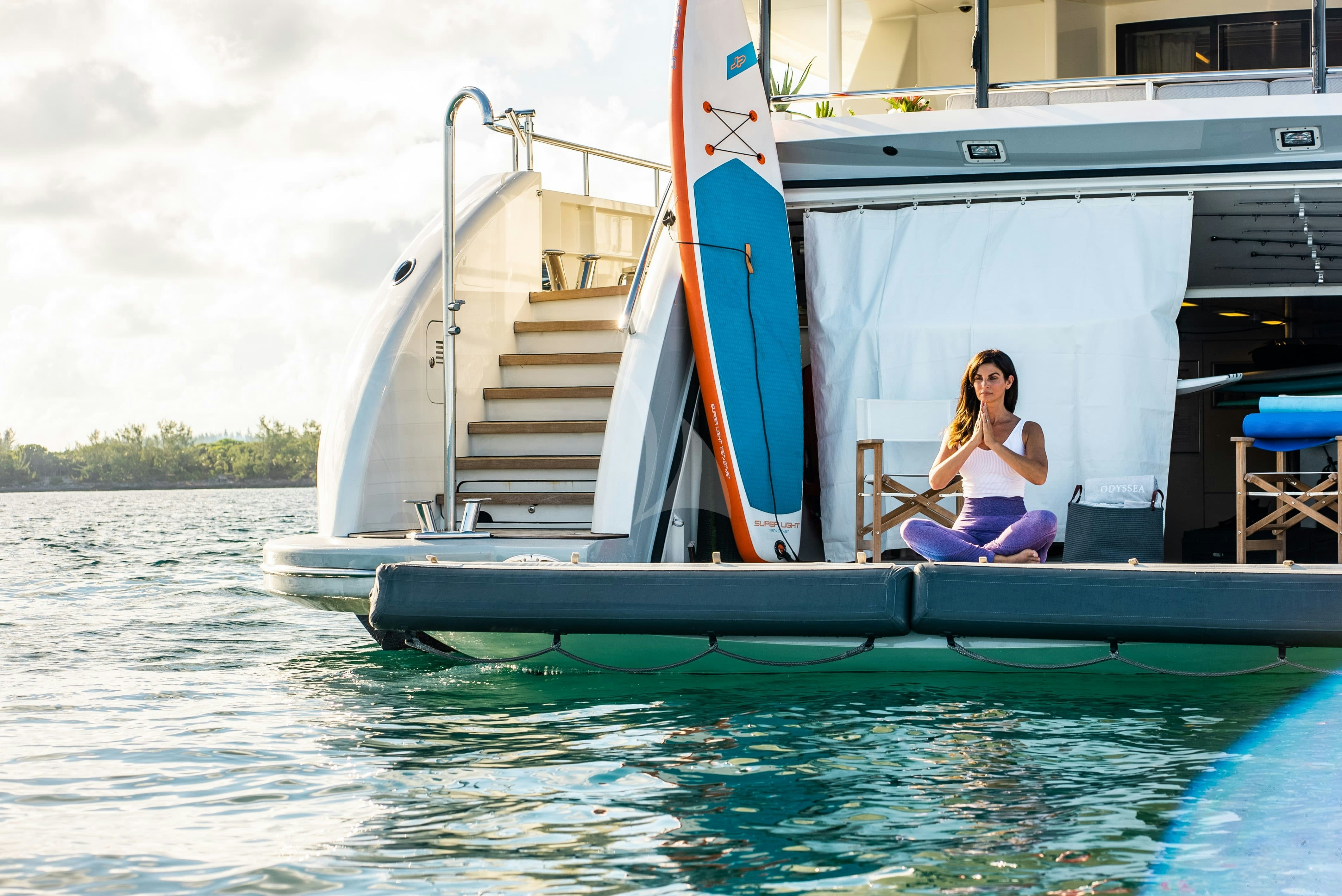 a person sitting on a boat aboard ODYSSEA Yacht for Charter
