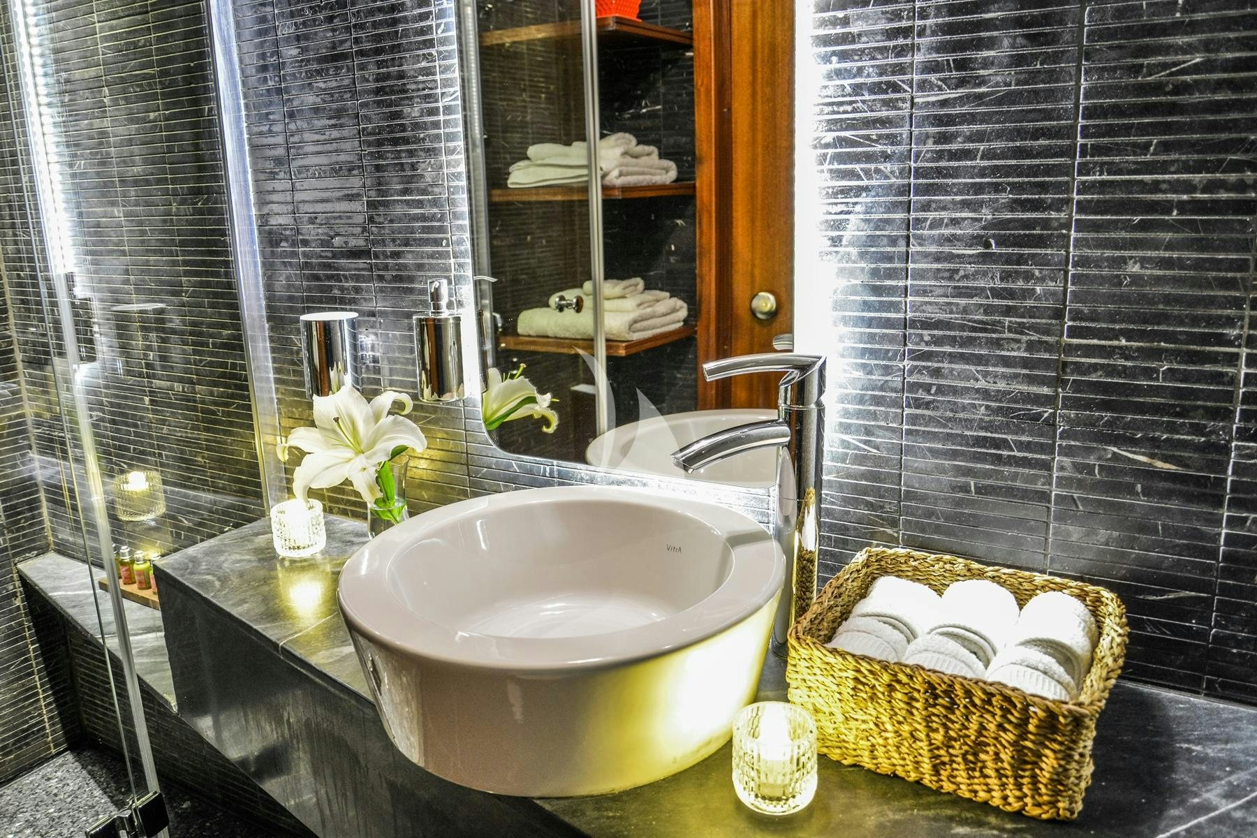 a bathroom with a sink and a basket aboard PAPA JOE Yacht for Charter