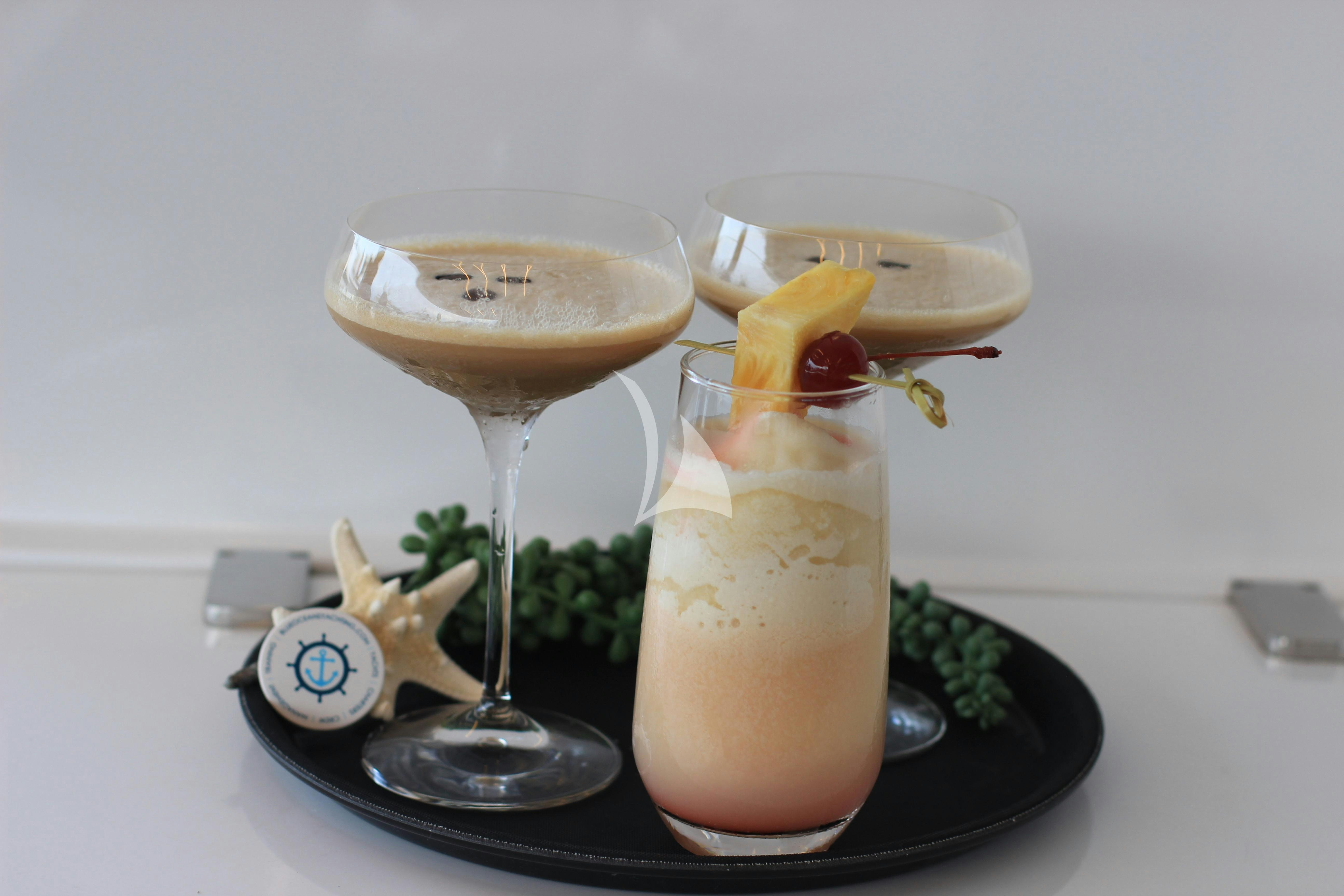 two glasses of liquid with ice and fruit on top aboard THE PEDDLER Yacht for Sale