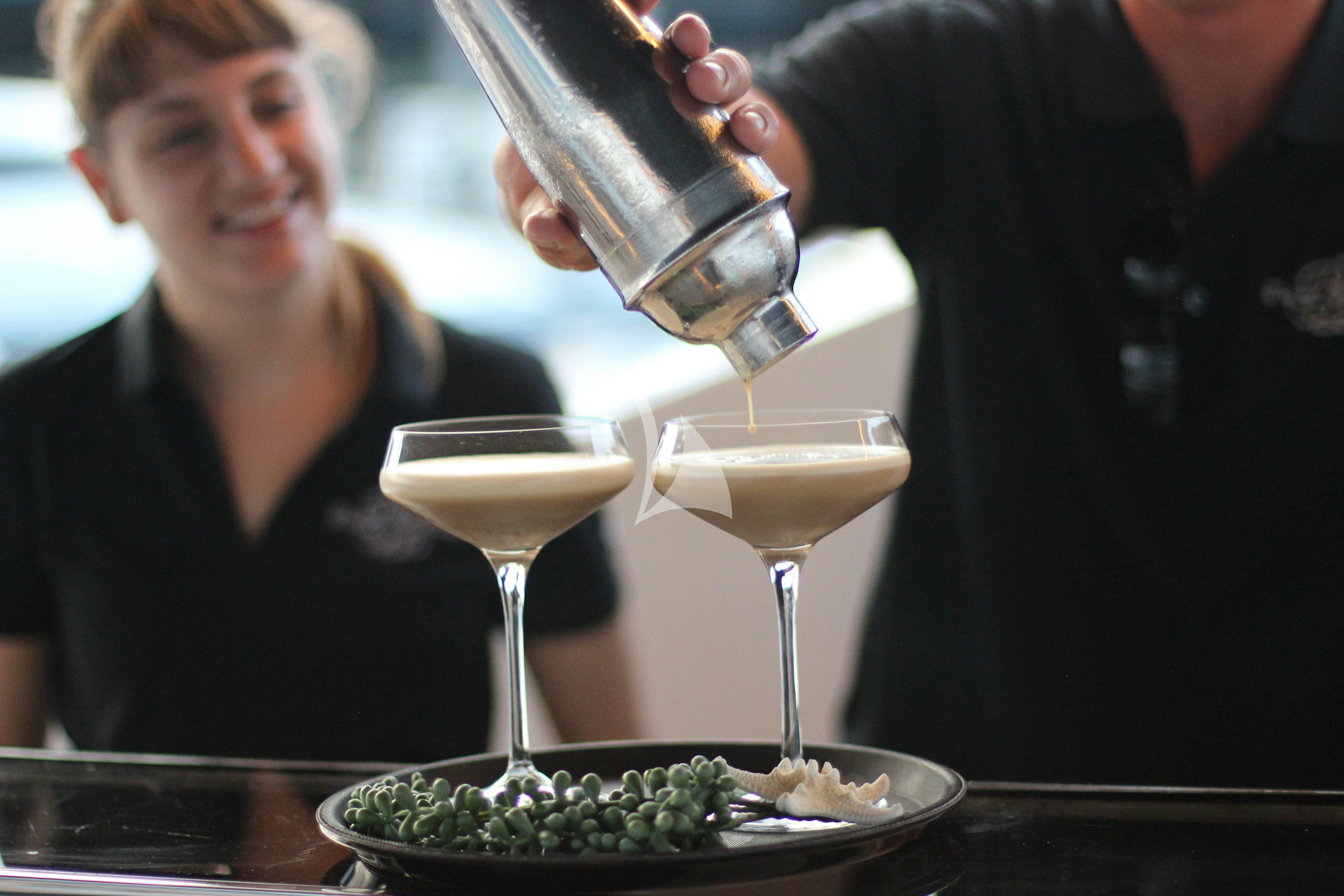 a person pouring a glass of wine aboard THE PEDDLER Yacht for Sale