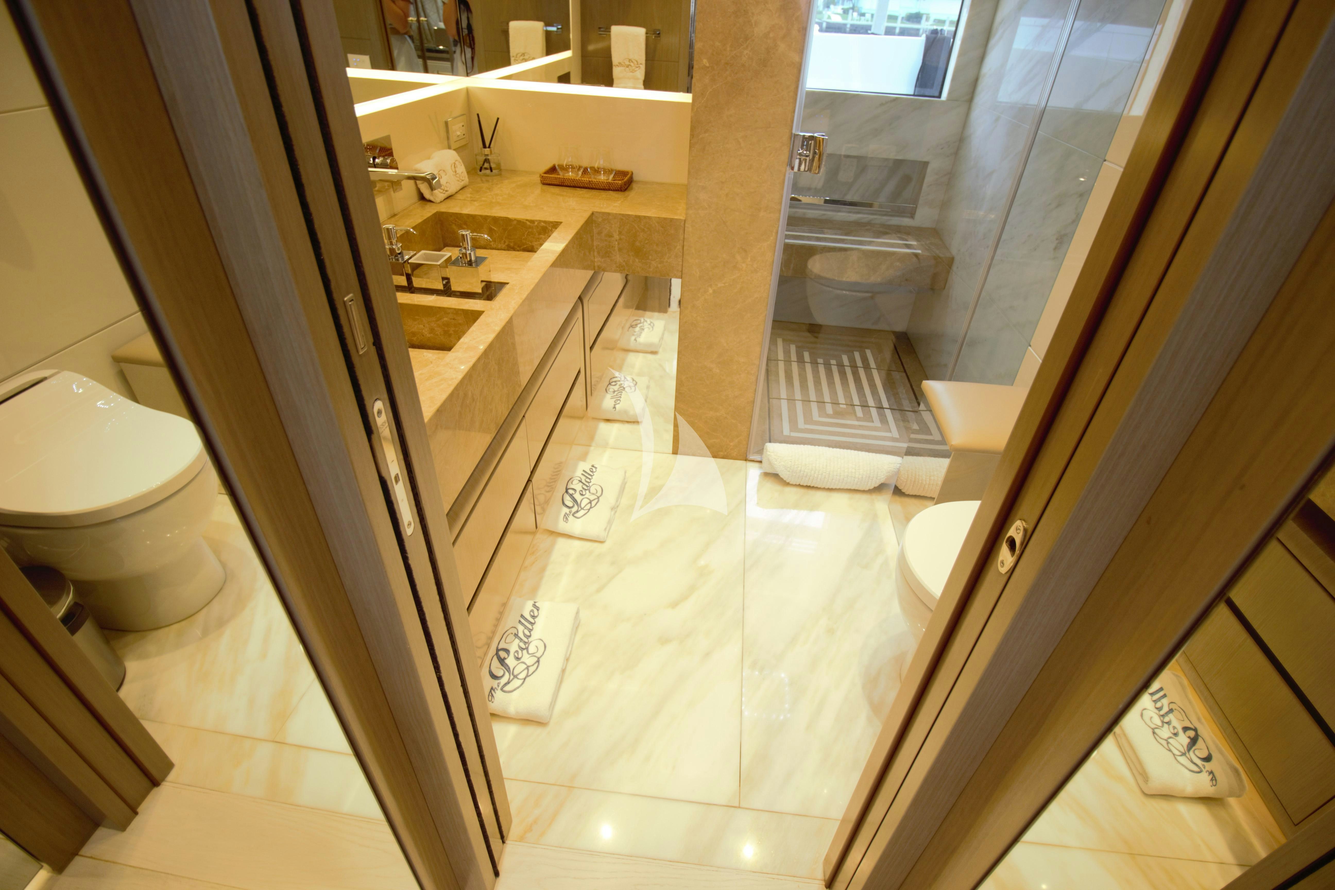a bathroom with a glass shower aboard THE PEDDLER Yacht for Sale