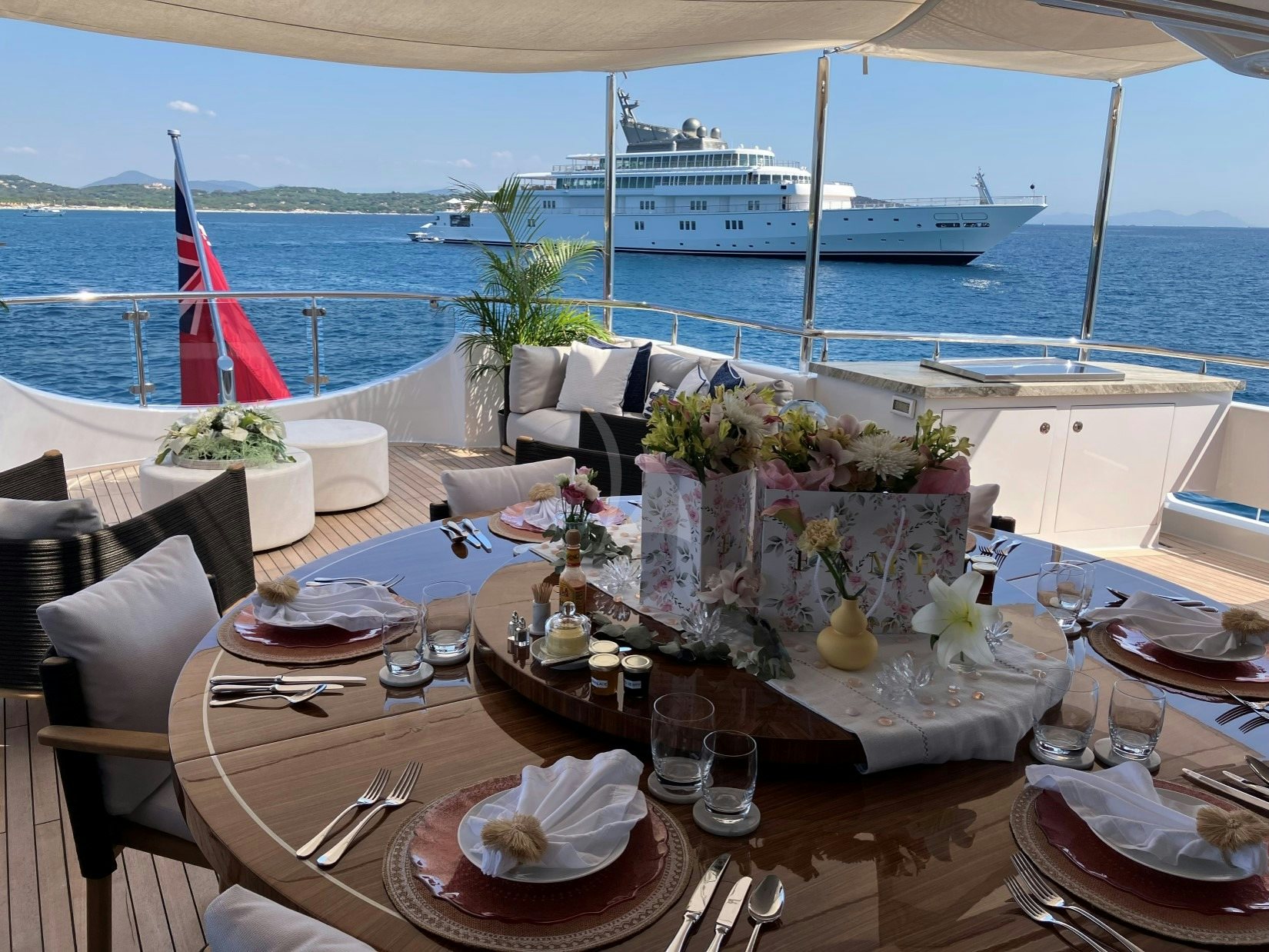 a table set with plates and glasses aboard SEANASH Yacht for Charter