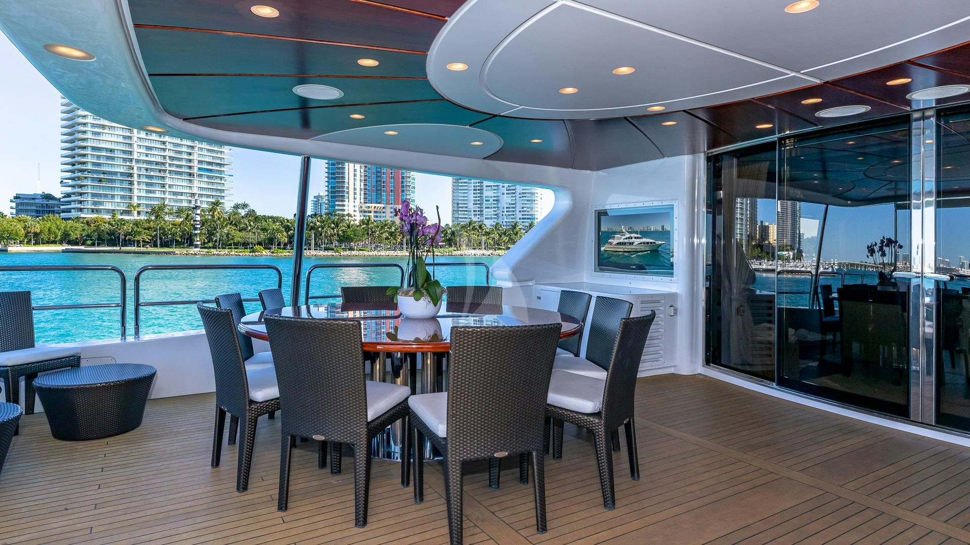 a room with a table and chairs and a pool aboard VIRTUE Yacht for Charter